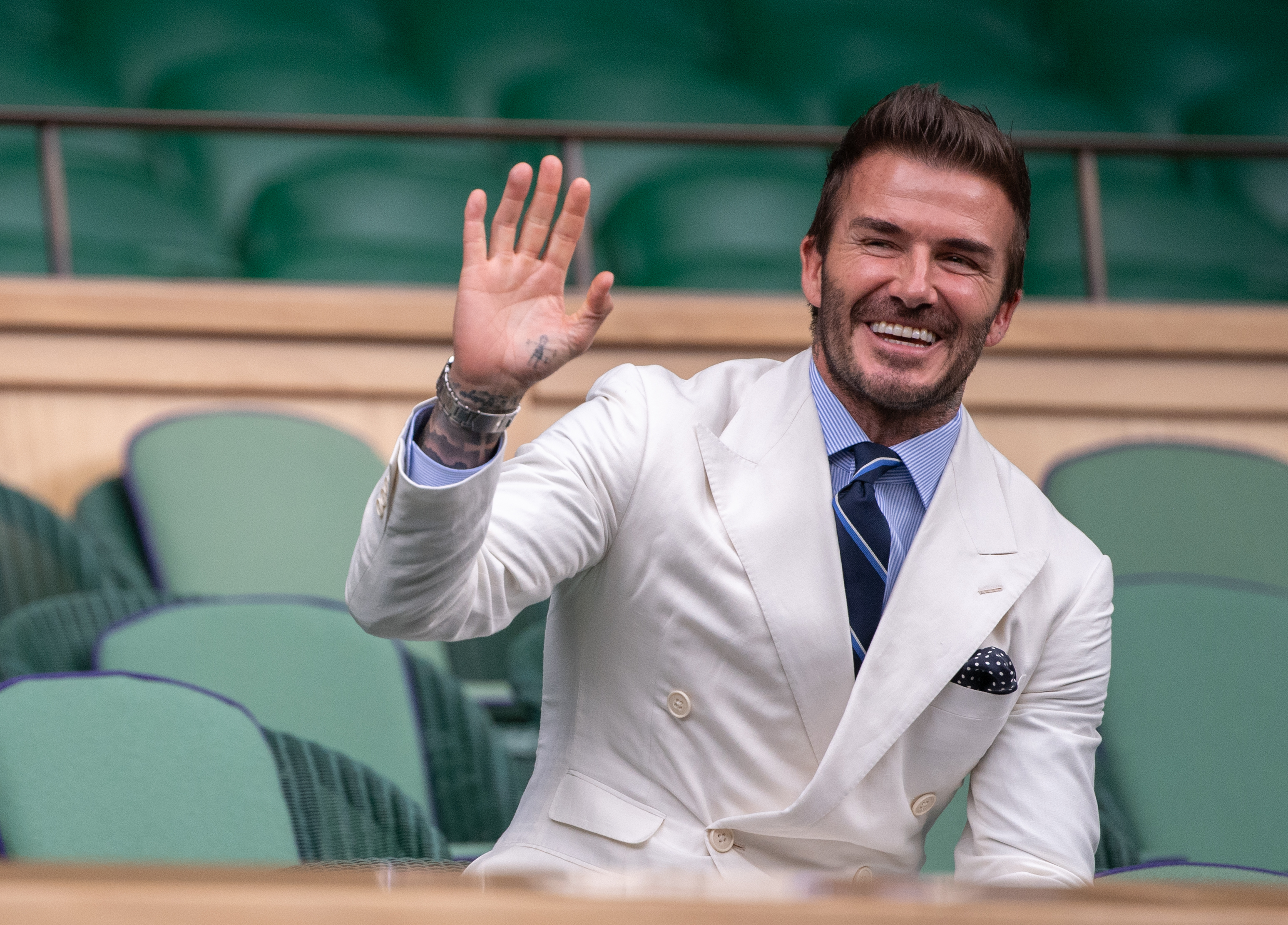 David Beckham waves to the crowd from the royal box on centre court on day eleven of Wimbledon at The All England Lawn Tennis and Croquet Club, Wimbledon. Picture date: Friday July 9, 2021.