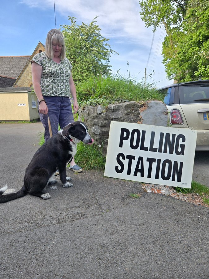Woman and dog outside polling station 