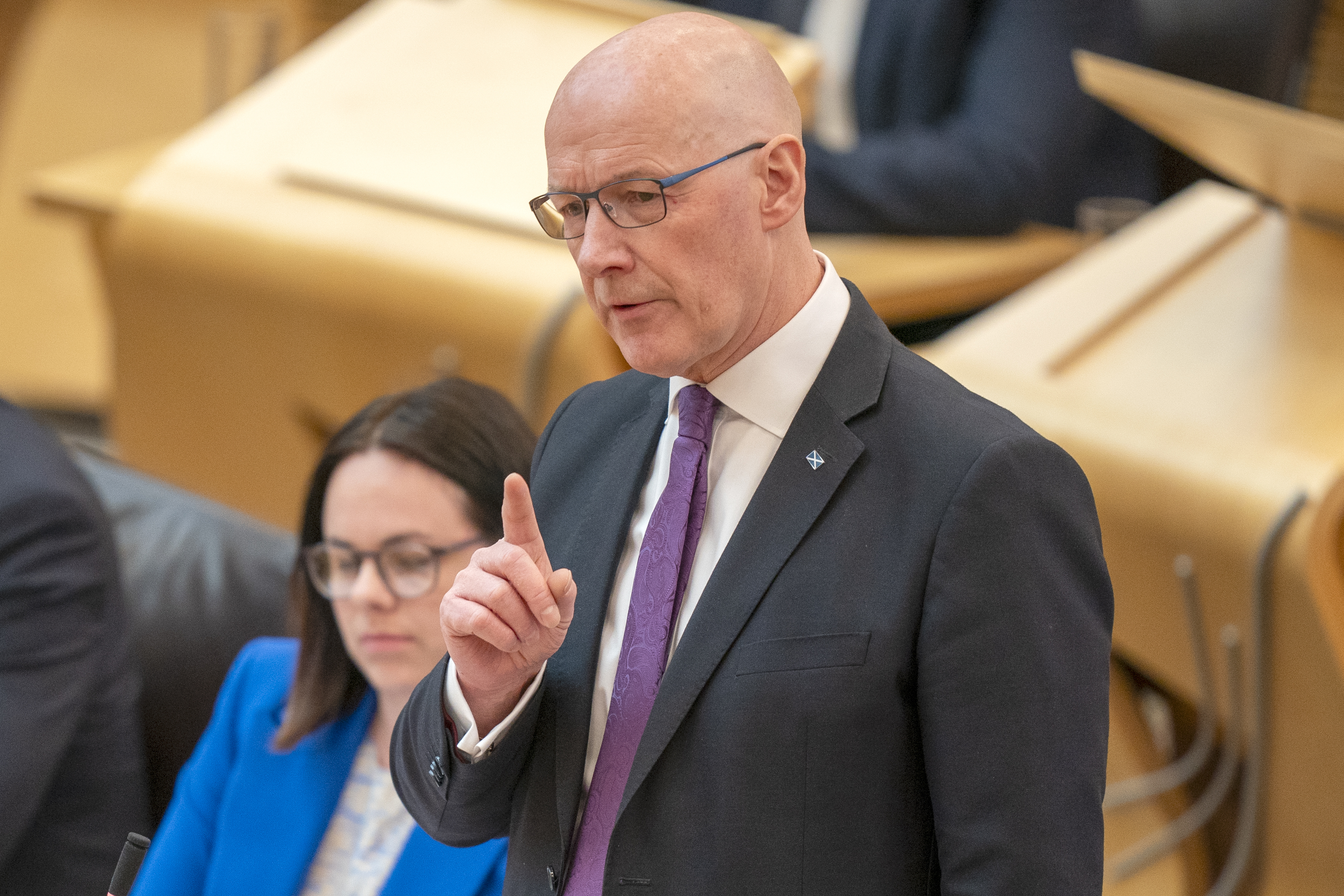John Swinney pointing with one hand while speaking in Holyrood