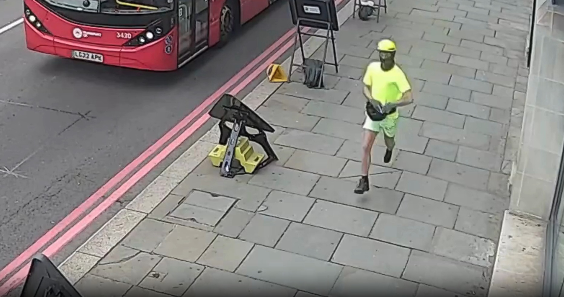 Duarte, wearing high vis shorts, tshirt and cycling cap, and a face covering, fleeing the scene.