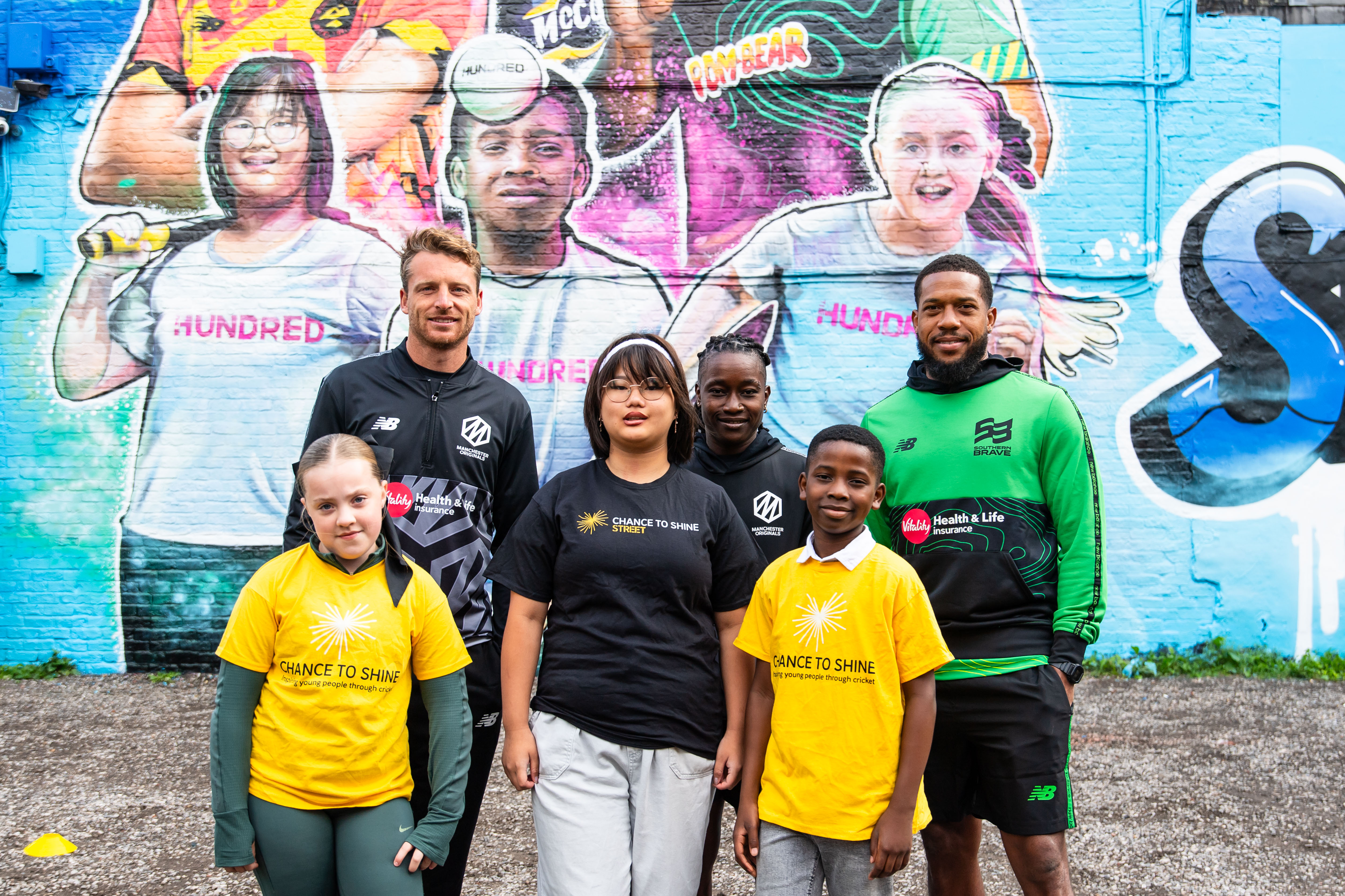Jos Buttler (top left) joins fellow Hundred stars and children from the Chance to Shine charity at a new mural in Manchester.