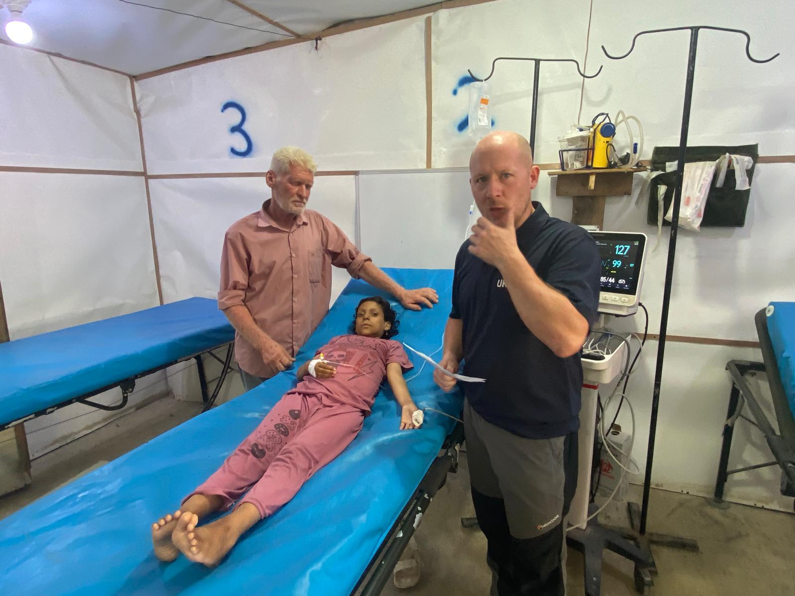 Sam Sears treating a girl named Noor in Gaza