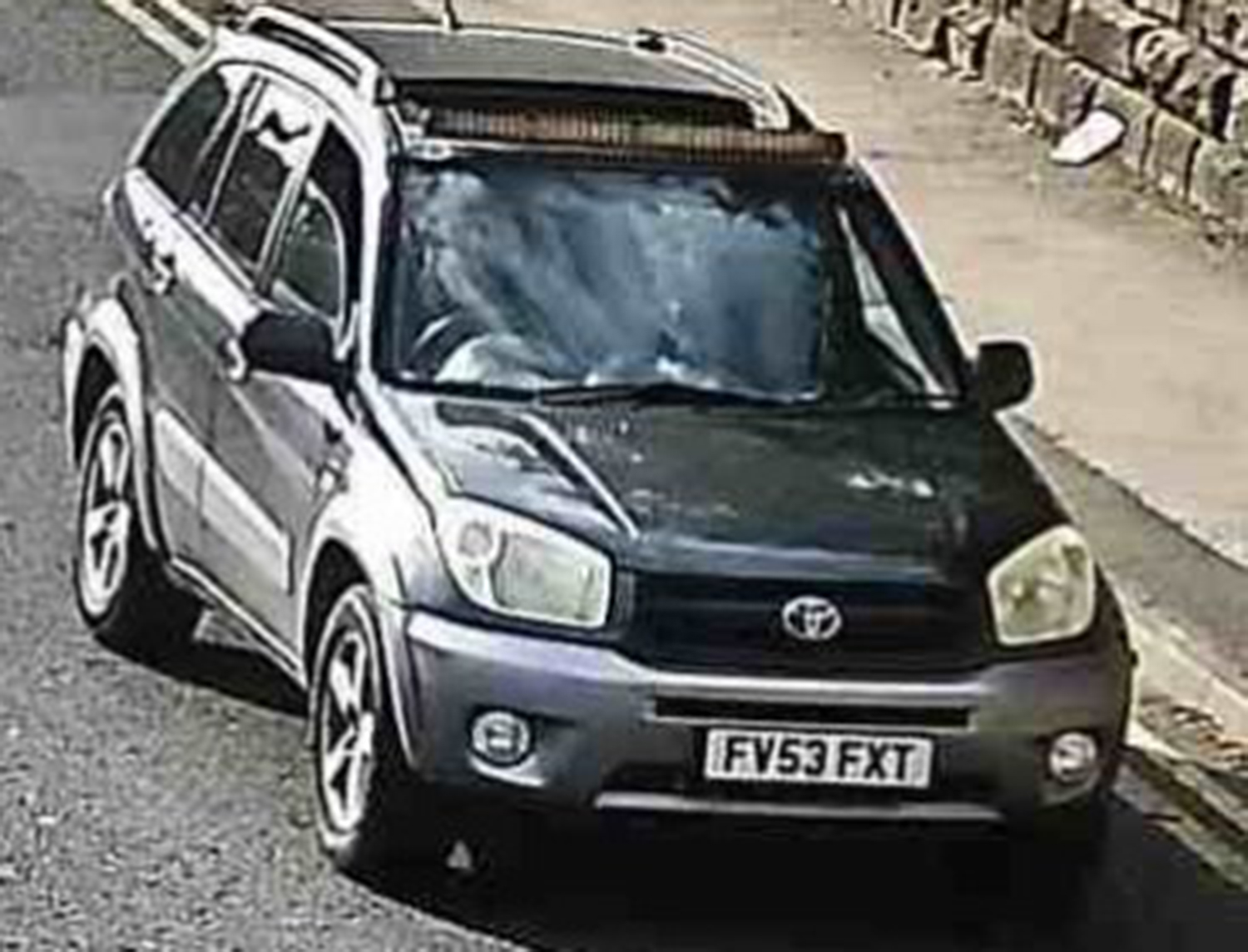 A still from CCTV footage, showing a Toyota RAV4 with a grey trim, displaying cloned plates