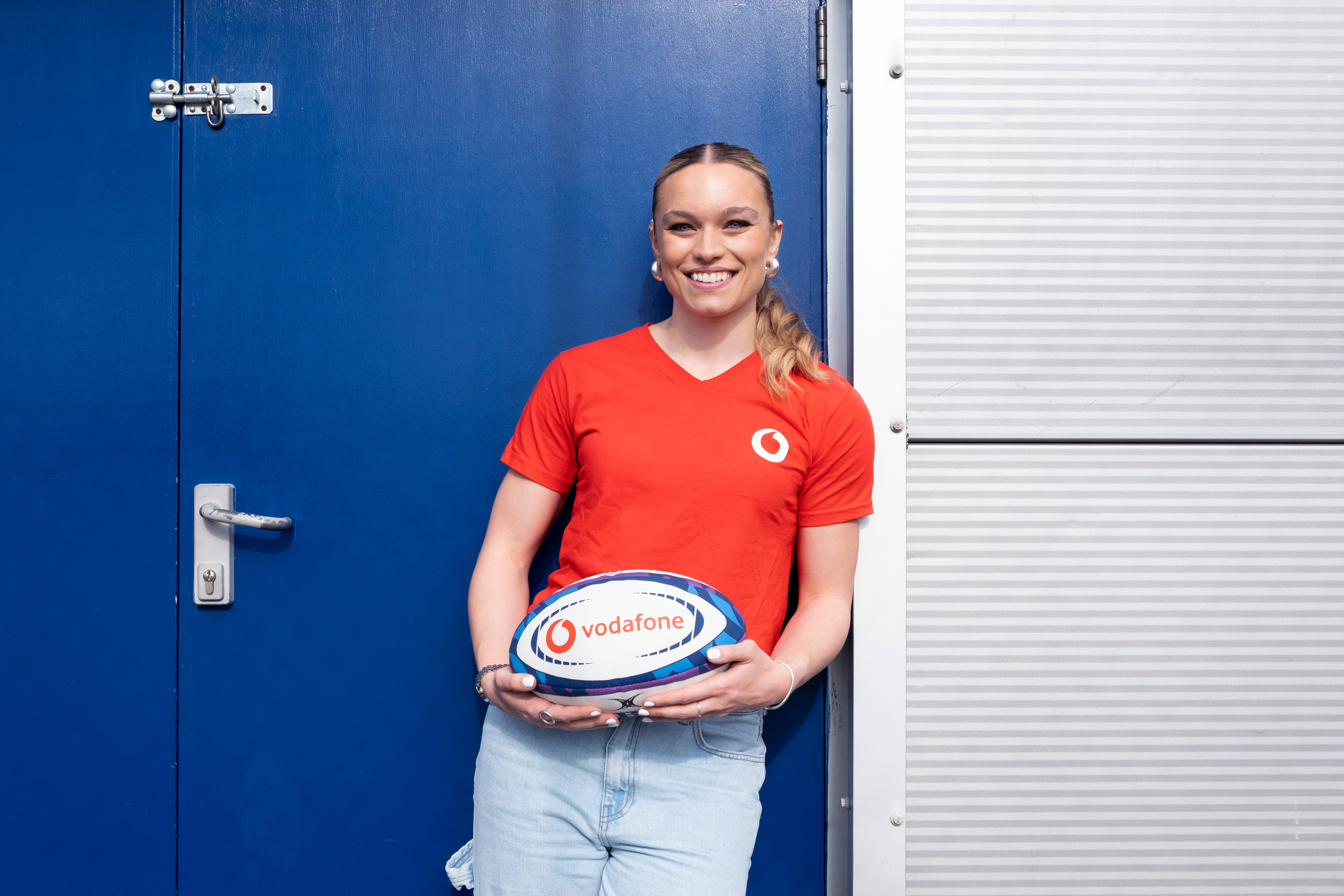 Former England Sevens player and Gladiators star Jodie Ounsley poses with a rugby ball.