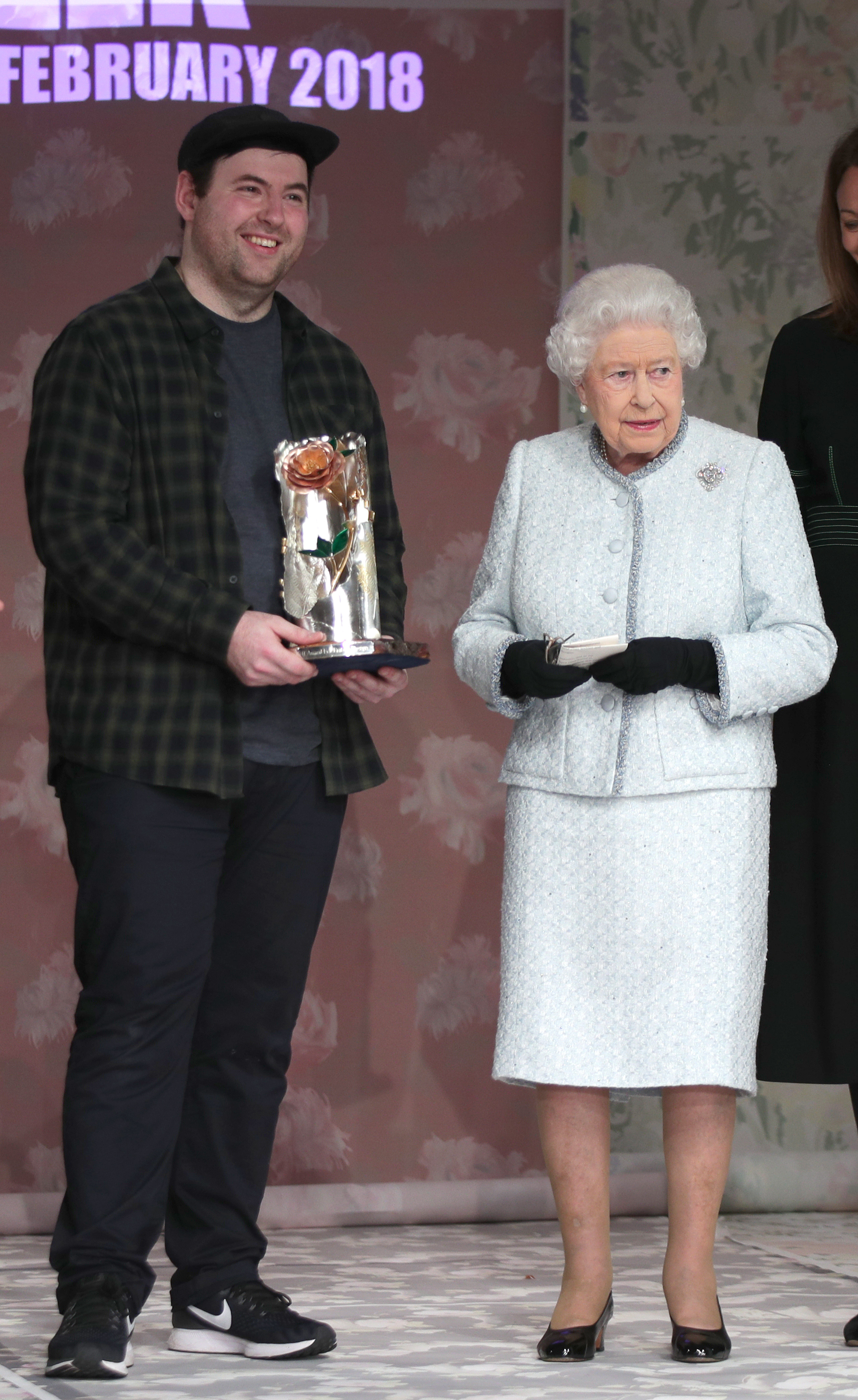 Queen Elizabeth II presents Richard Quinn with the inaugural Queen Elizabeth II Award for British Design, as she visits London Fashion Week's BFC Show Space in central London.
