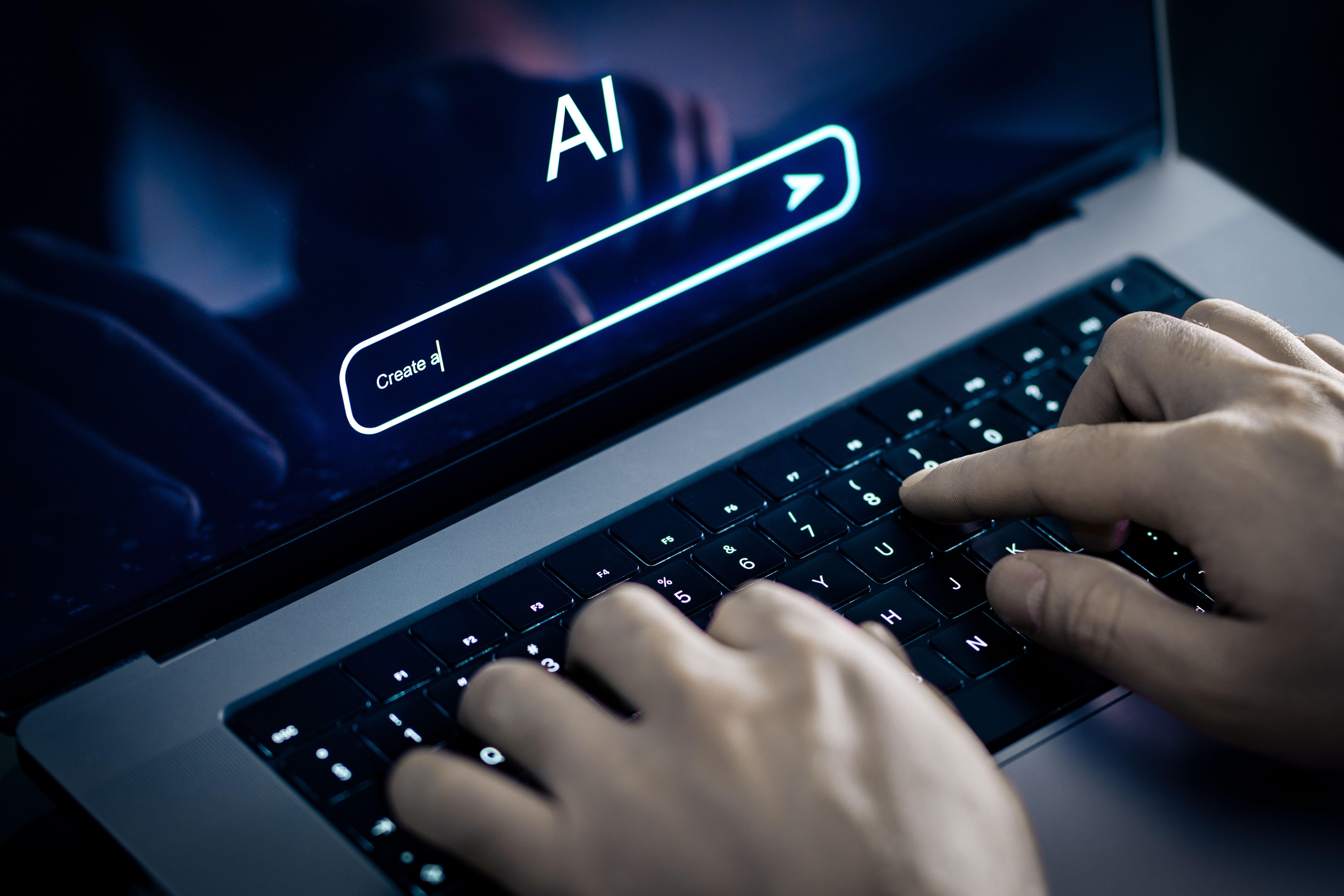 Hands on laptop using AI prompt to generate content