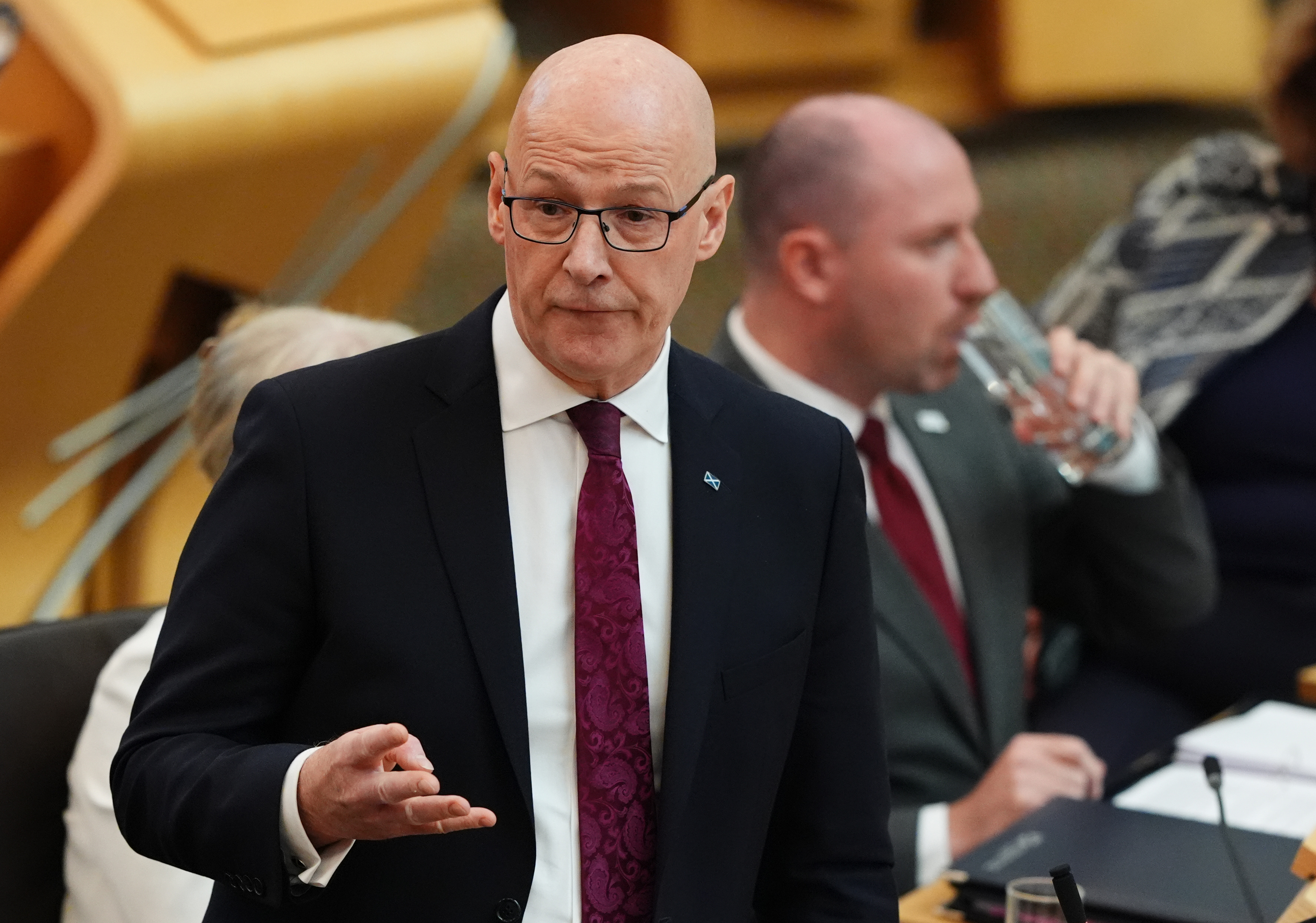 John Swinney standing while speaking during FMQs