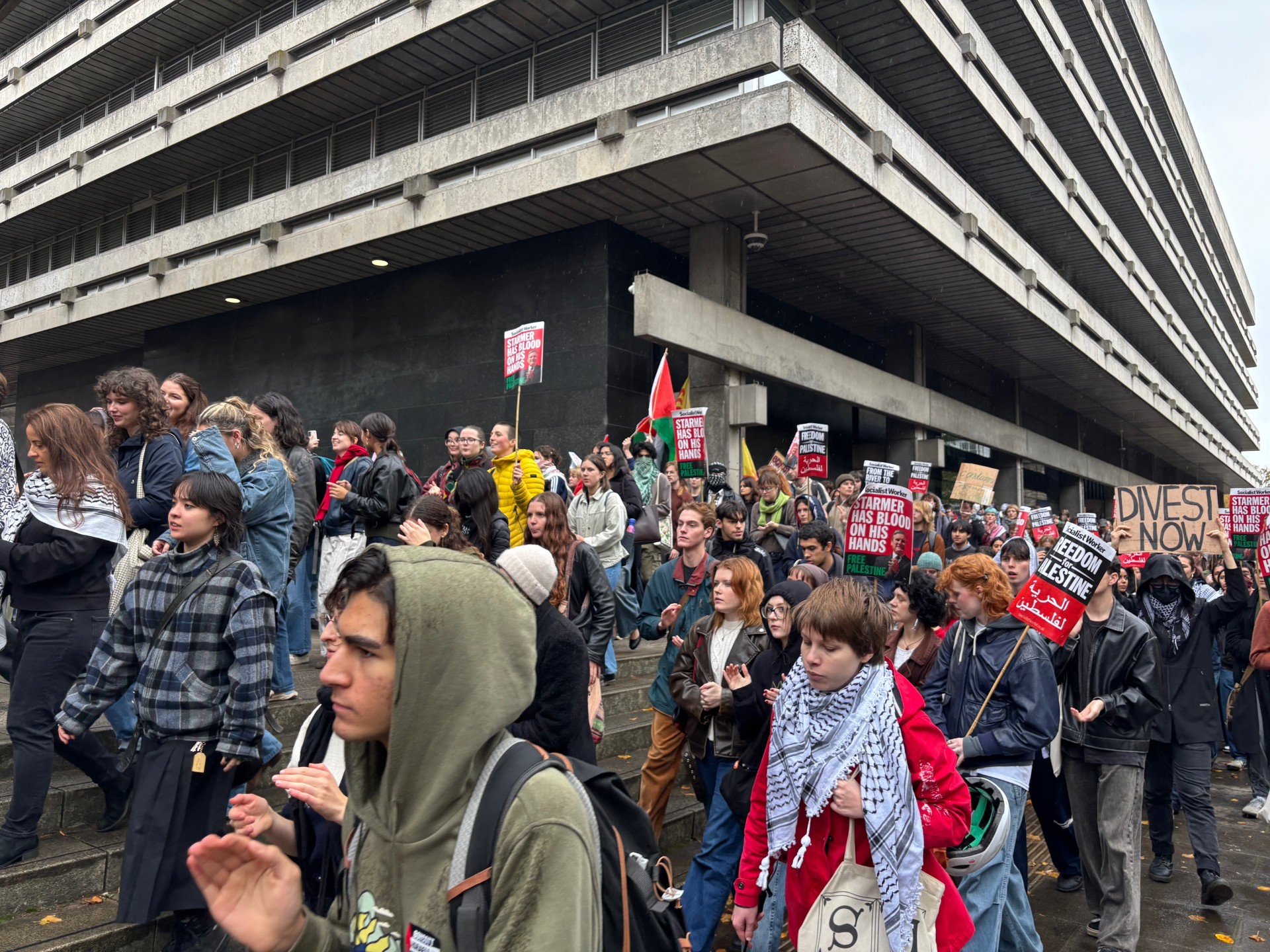 Protesters marching past a building