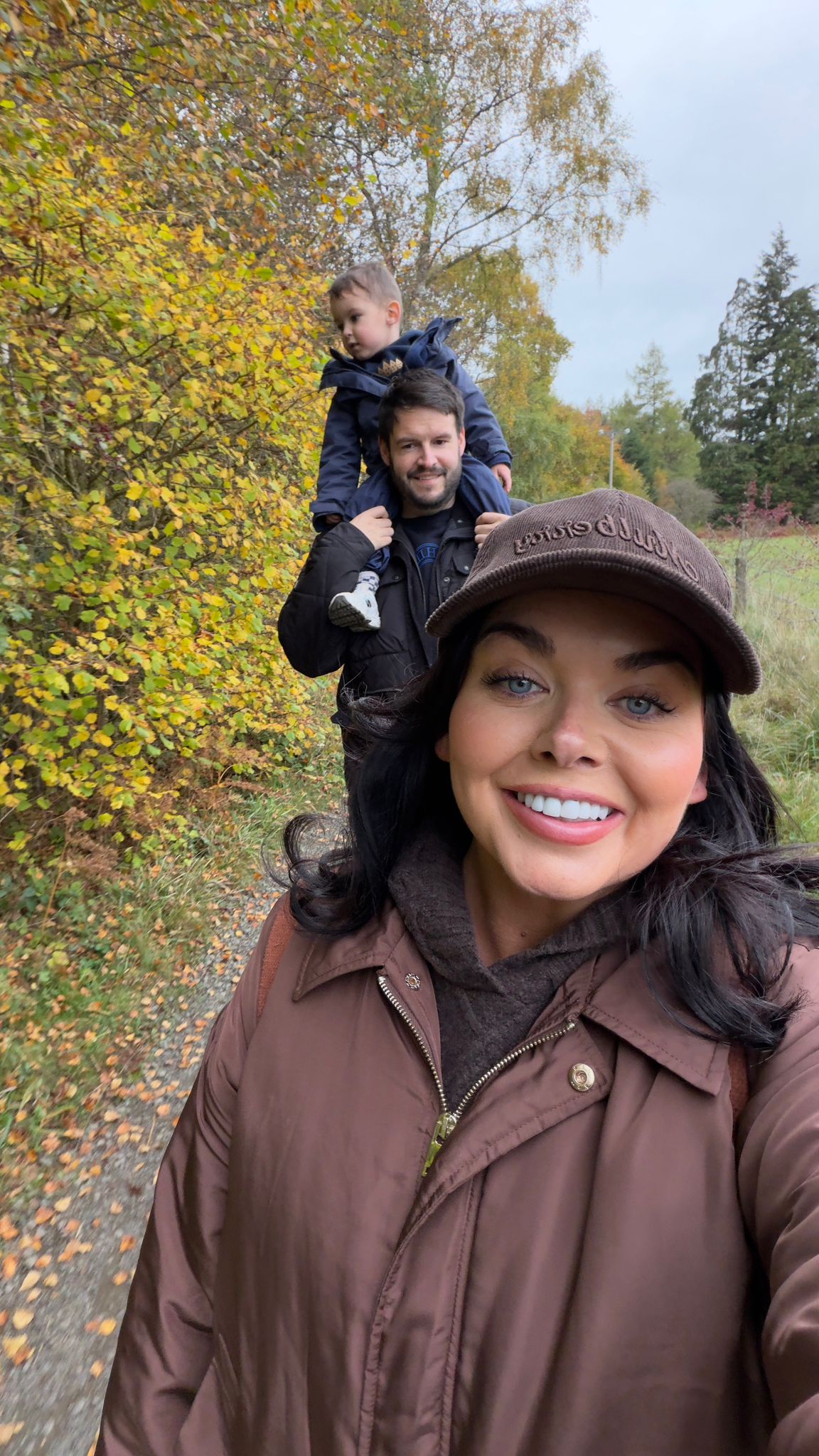 Scarlett Moffatt and partner Scott Dobinson with son Jude on his shoulderson a country lane (Scarlett Moffatt/PA)
