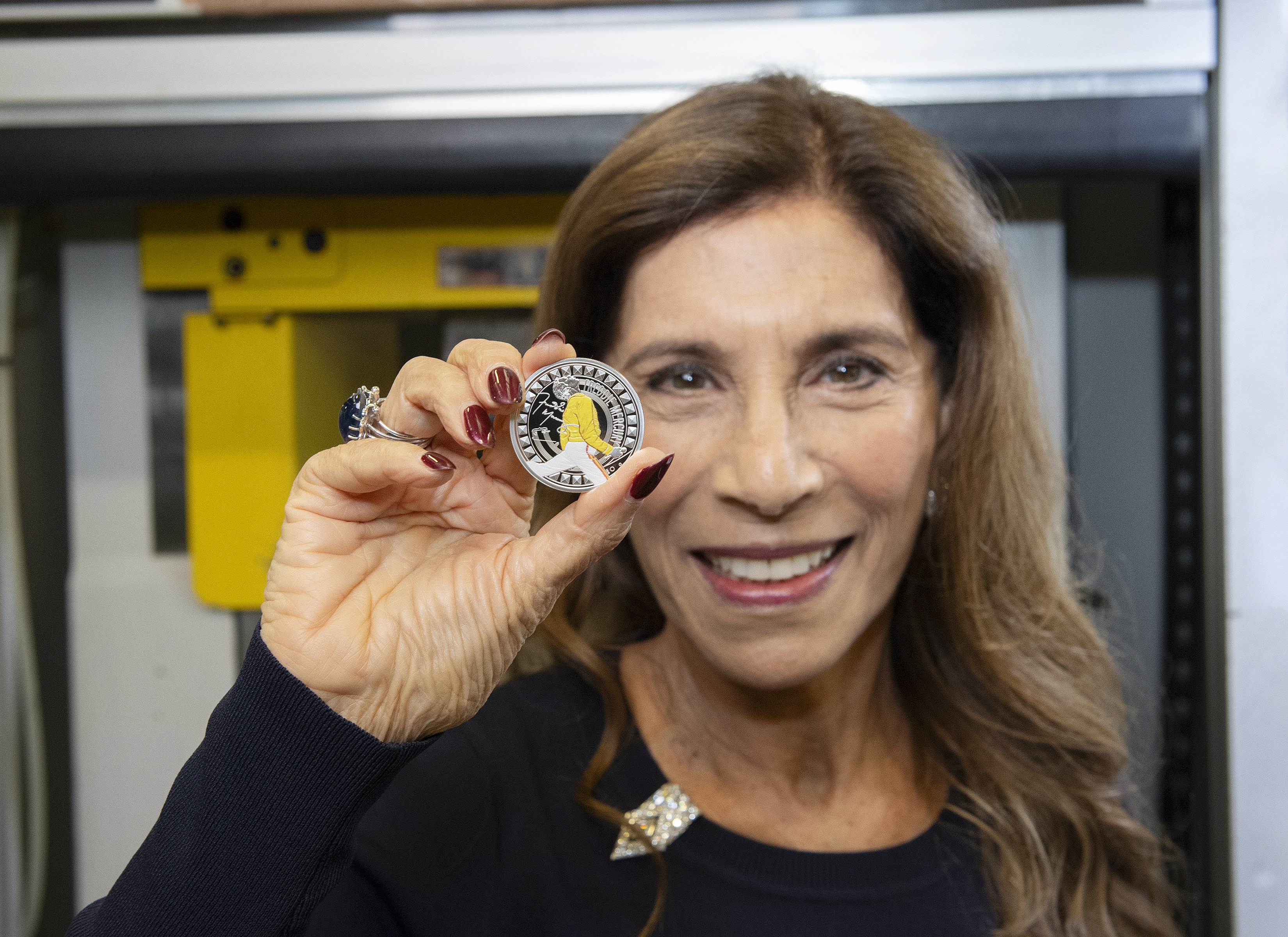 Kashmira Bulsara holding a Freddie Mercury coin