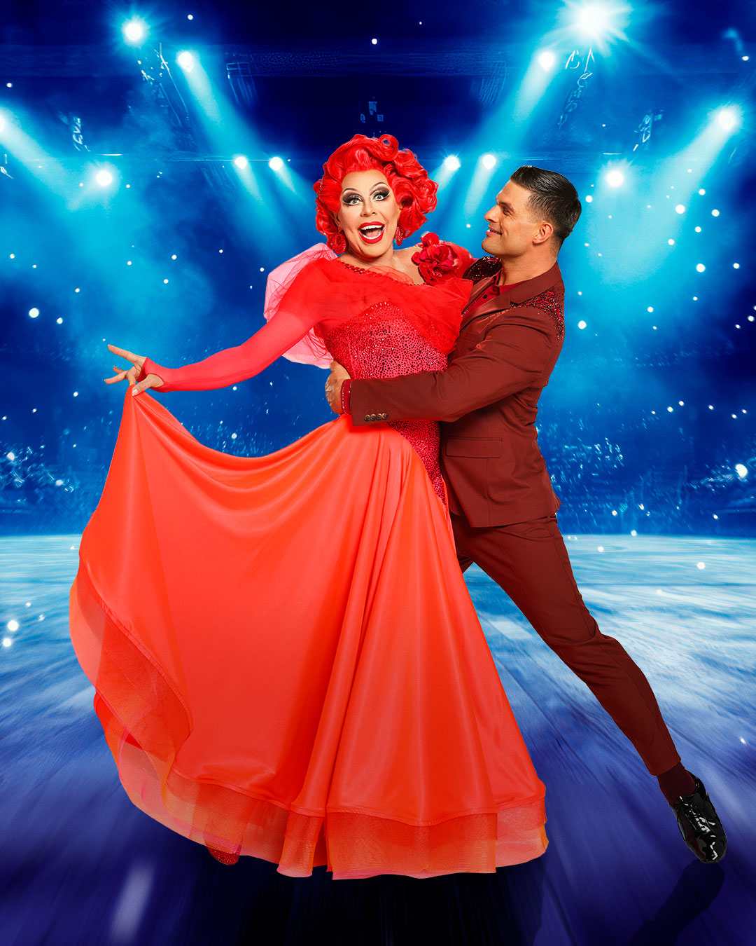 La Voix smiling alongside Aljaz Skorjanec in a mock ballroom