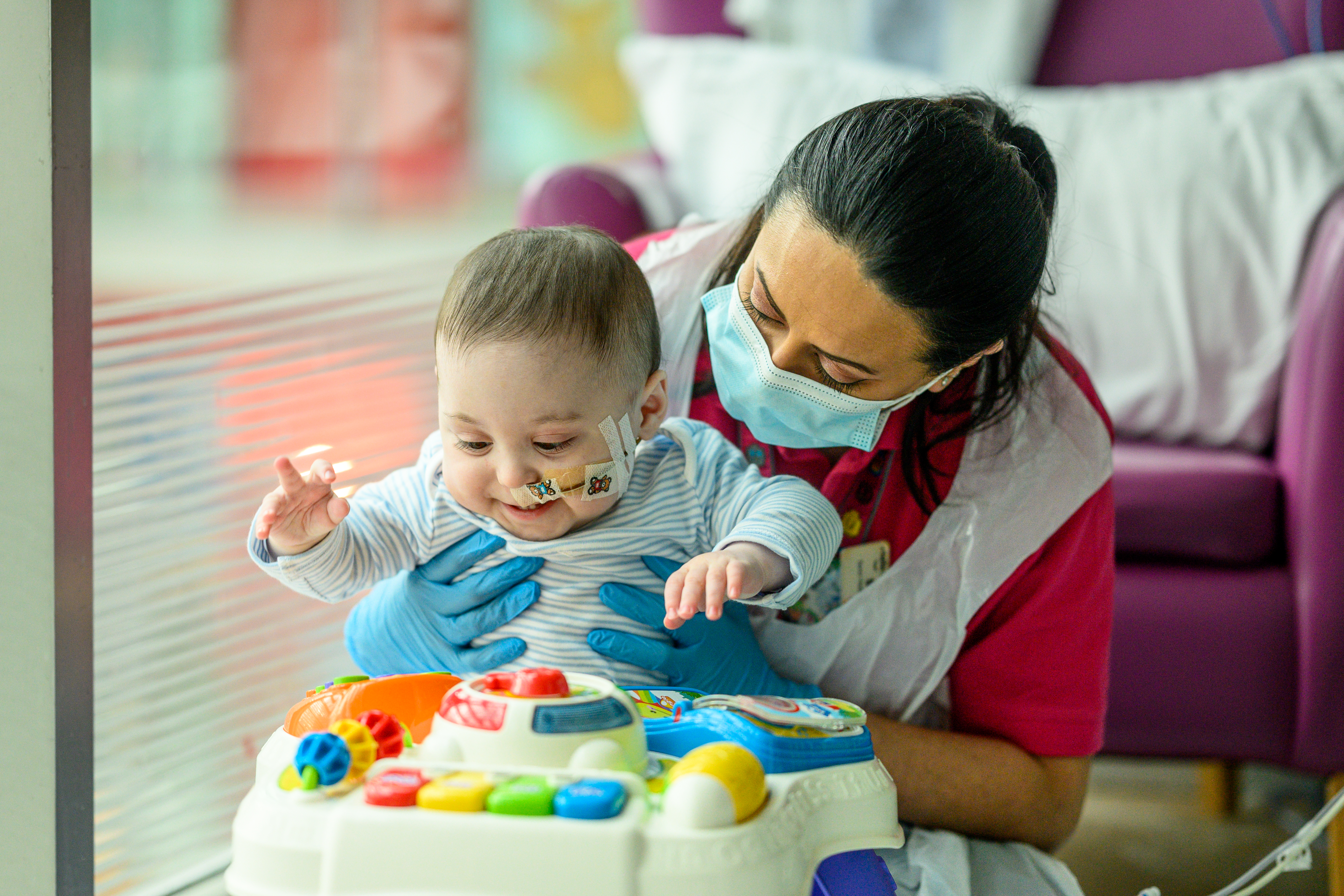 Bertie with a member of staff at Evelina Children's Hospital 
