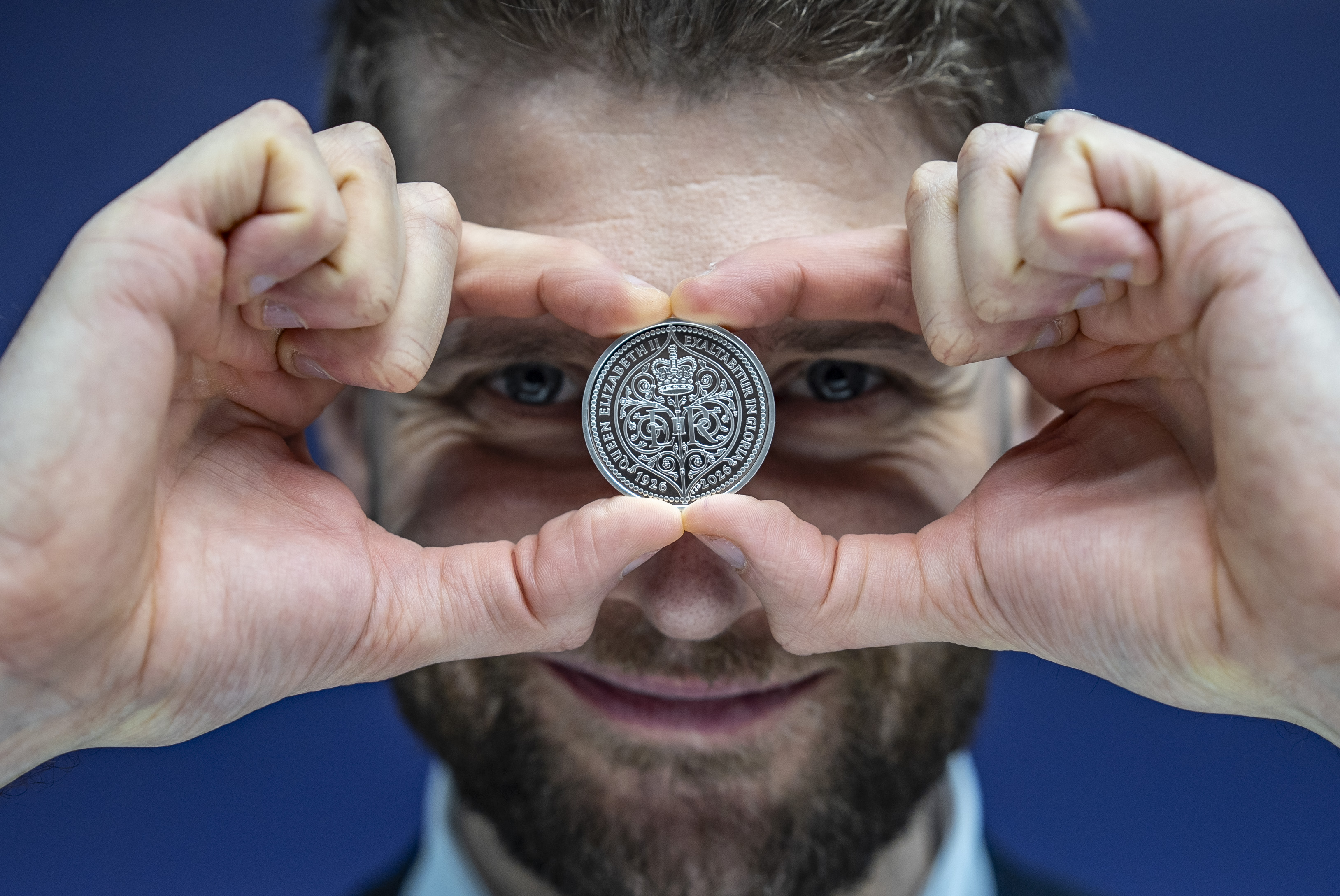 A new Royal Mint £5 coin being held
