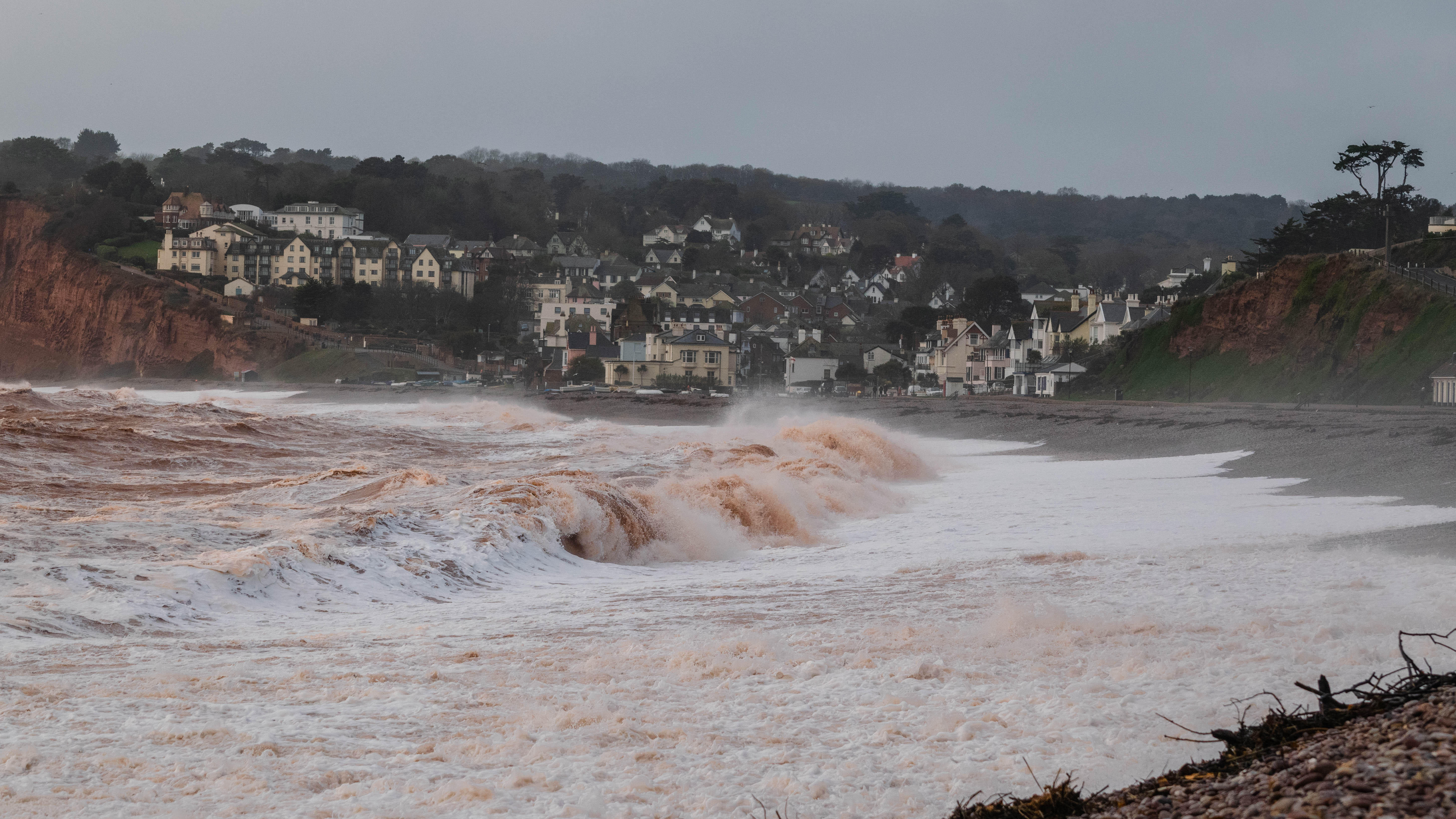 Storm waves crashing onto the pebbled beach at Budleigh Salterton in Devon