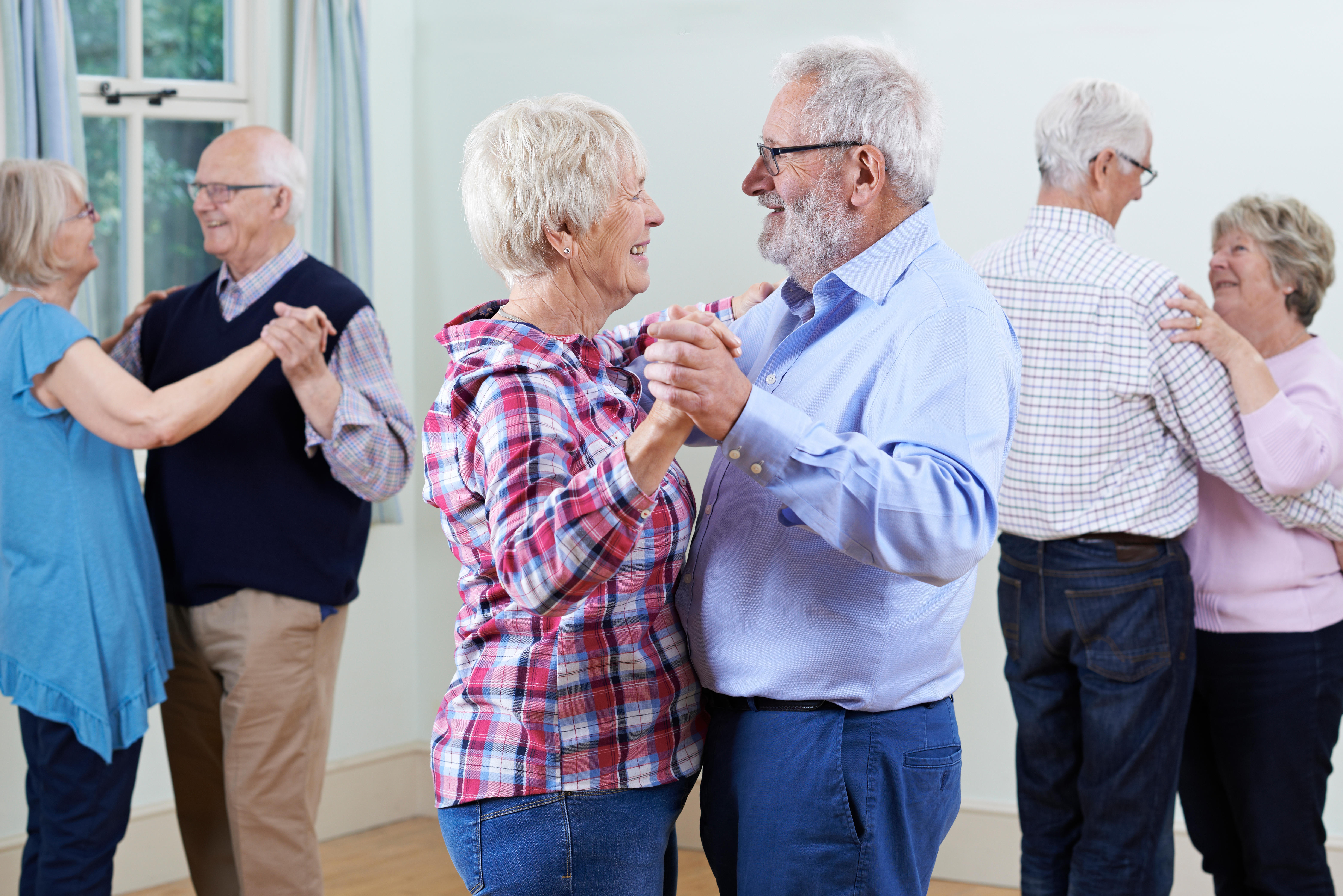 Group Of Seniors Enjoying Dancing Club Together