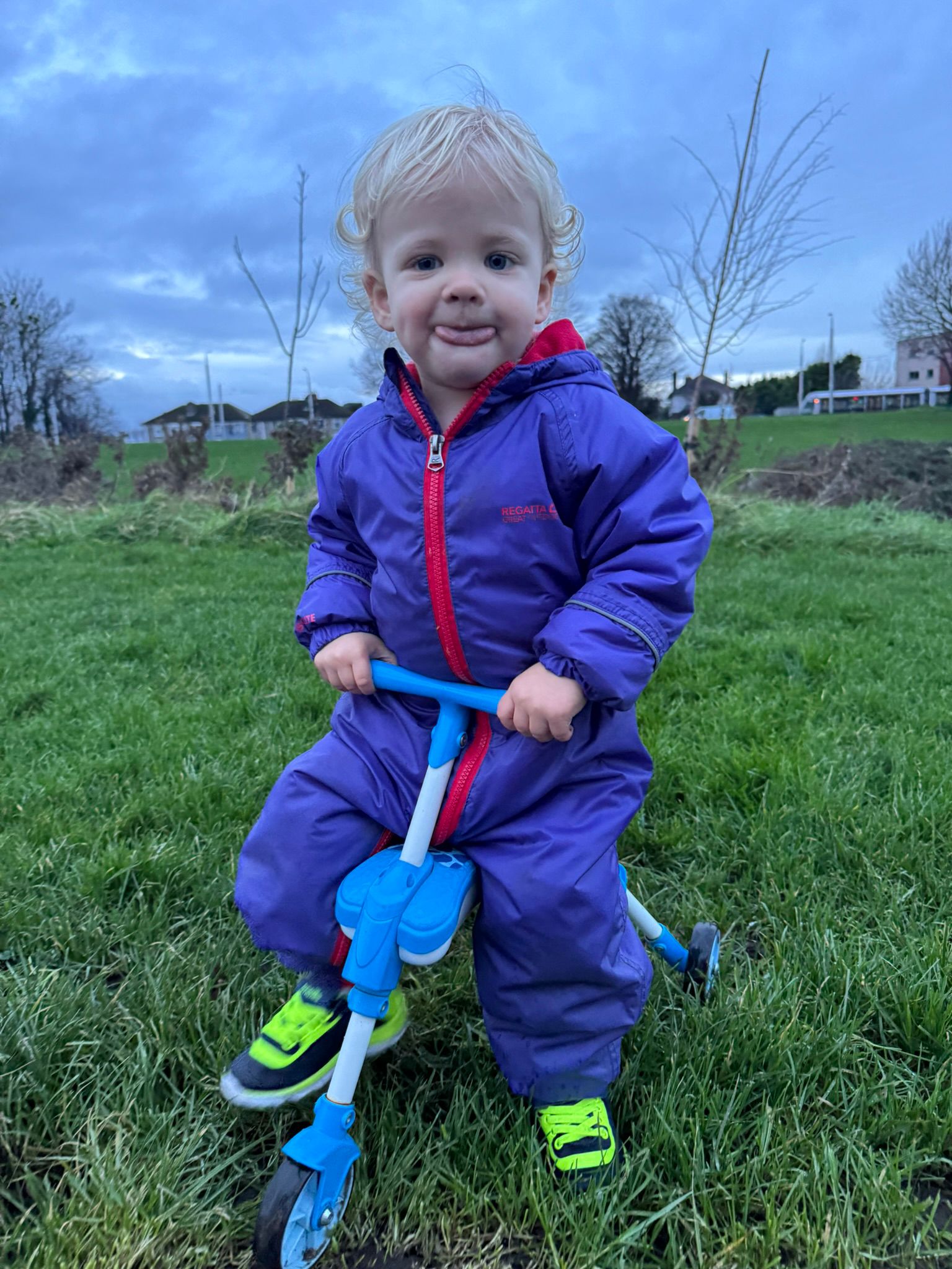 One-year-old Ali riding a tricycle
