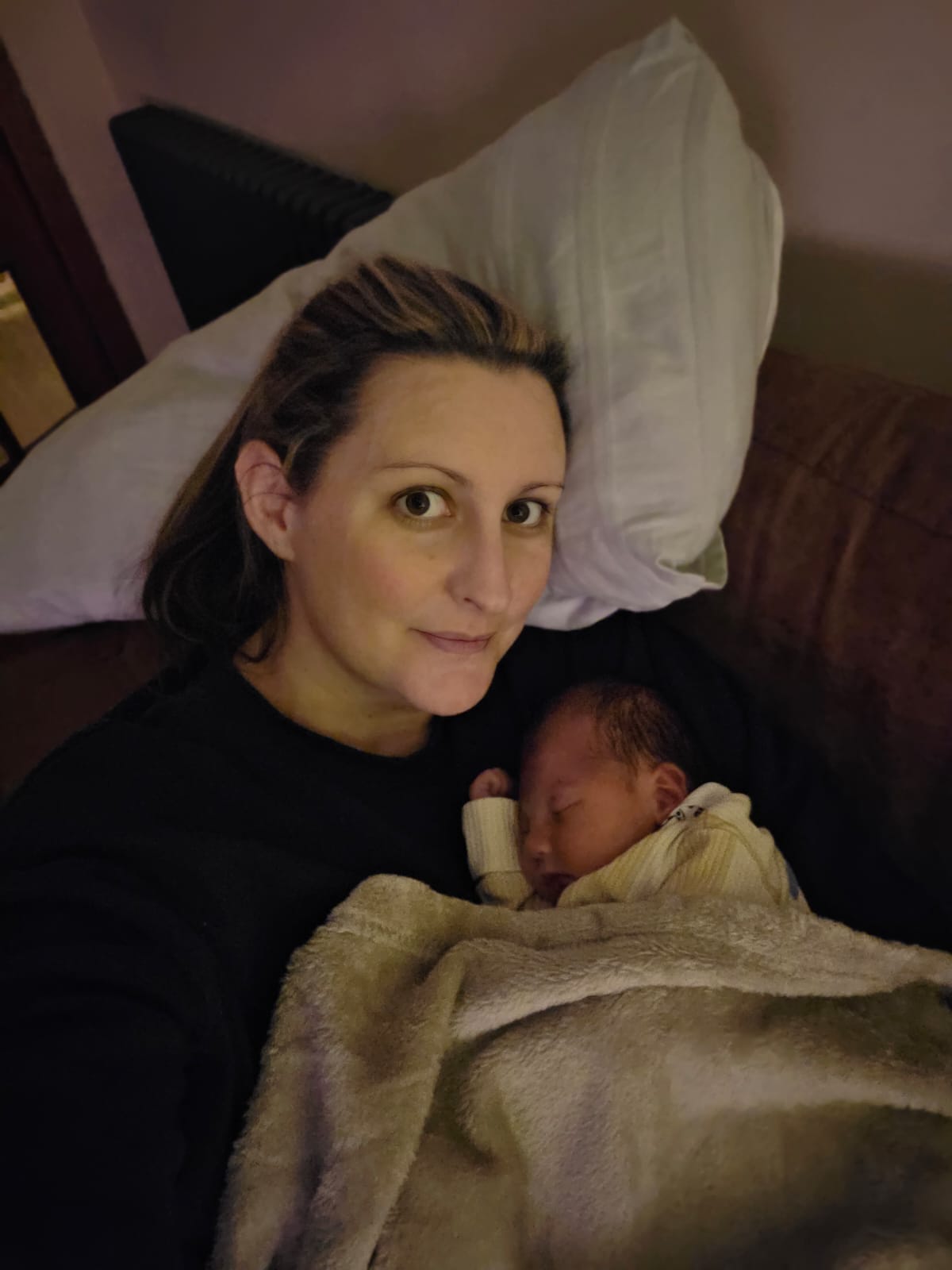 Alicia Hardie cuddling with newborn daughter Cora 