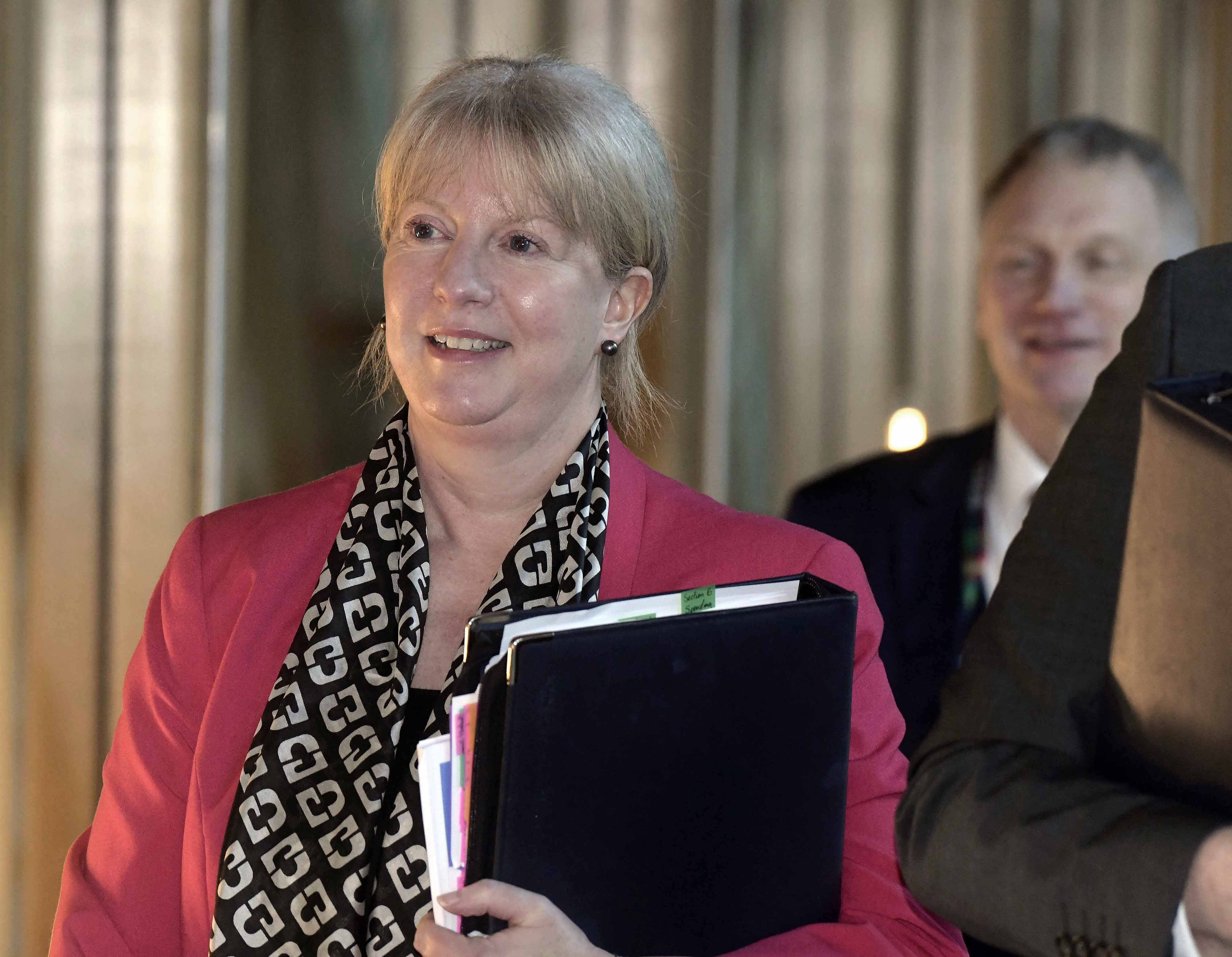 Shona Robison smiling while walking in Holyrood