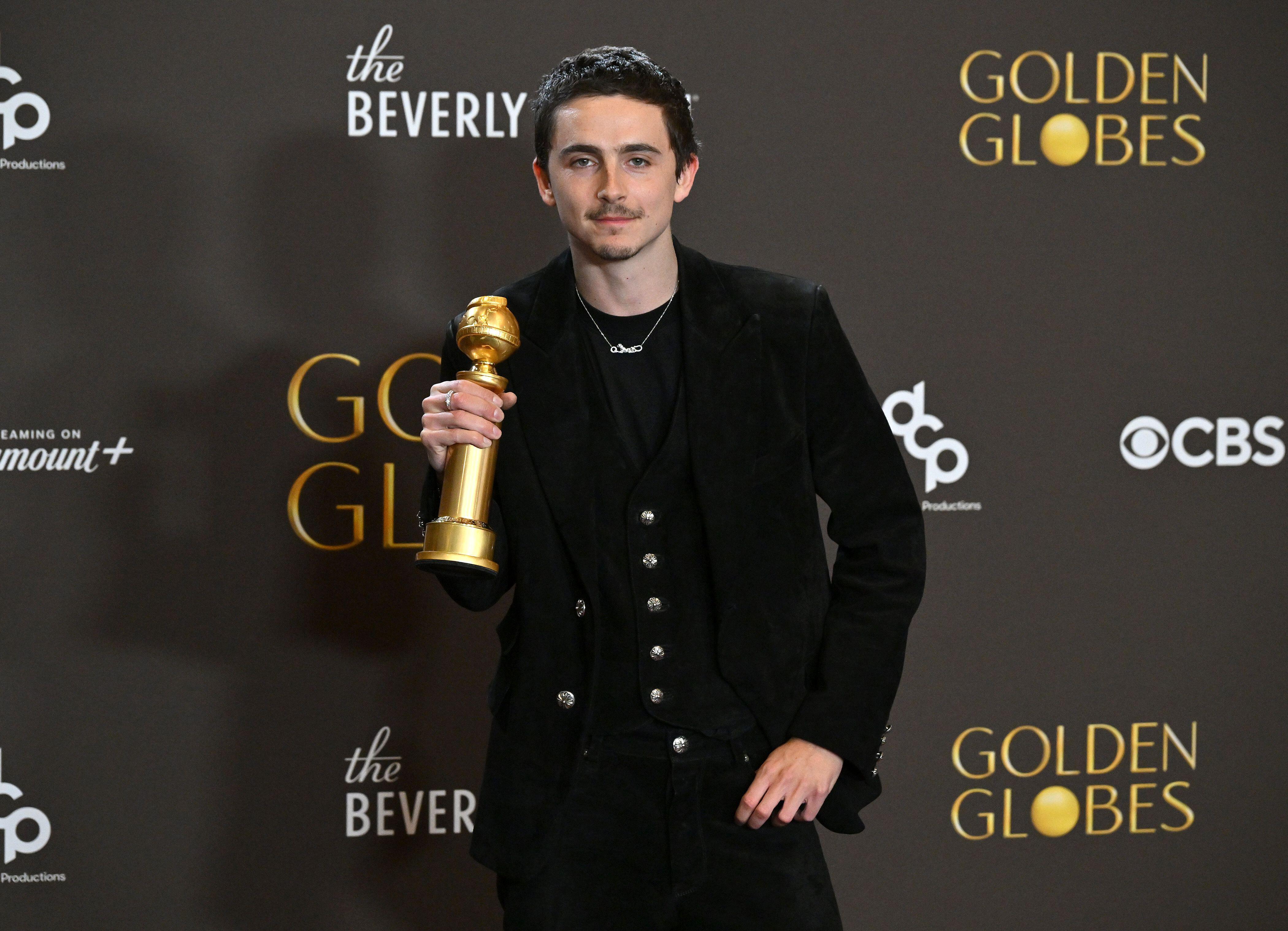 Timothee Chalamet holding a Golden Globe award in the press room at the 83rd Golden Globe Awards at the Beverly Hilton Hotel on January 11, 2025 