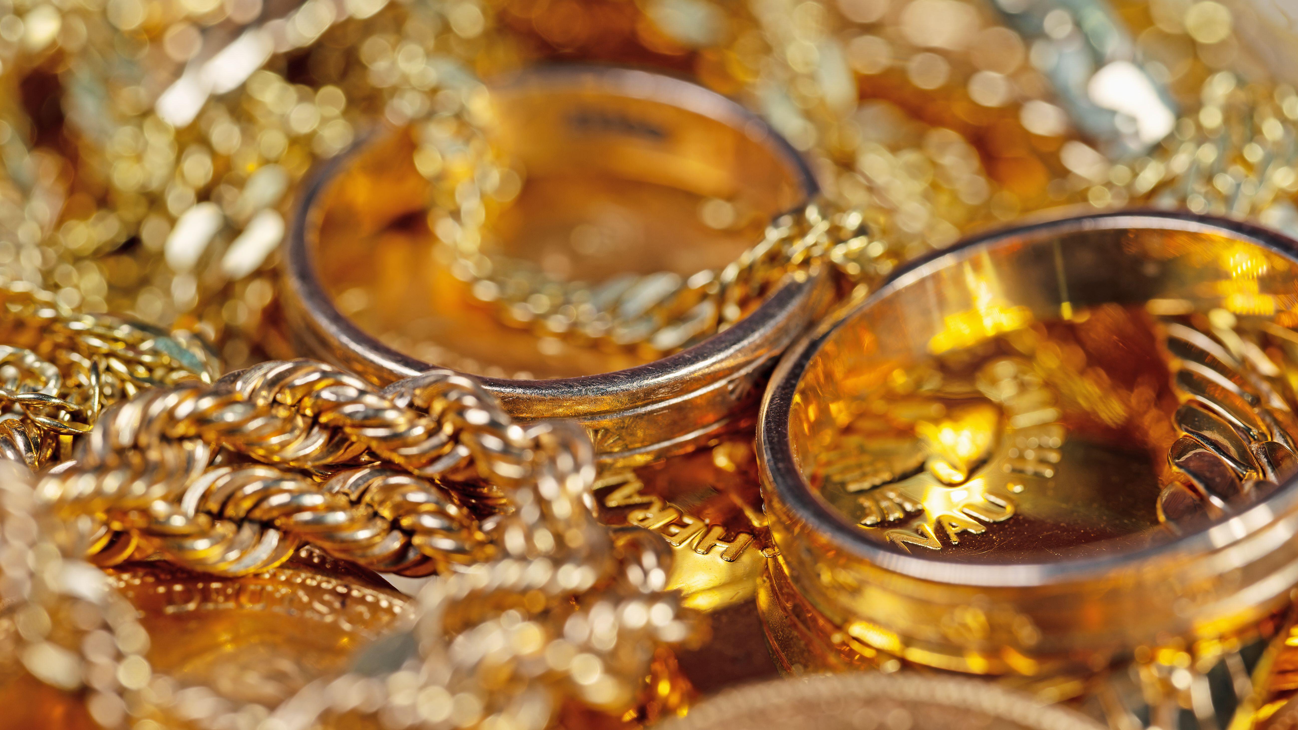 Gold jewellery, gold coins and gold bars in a close-up