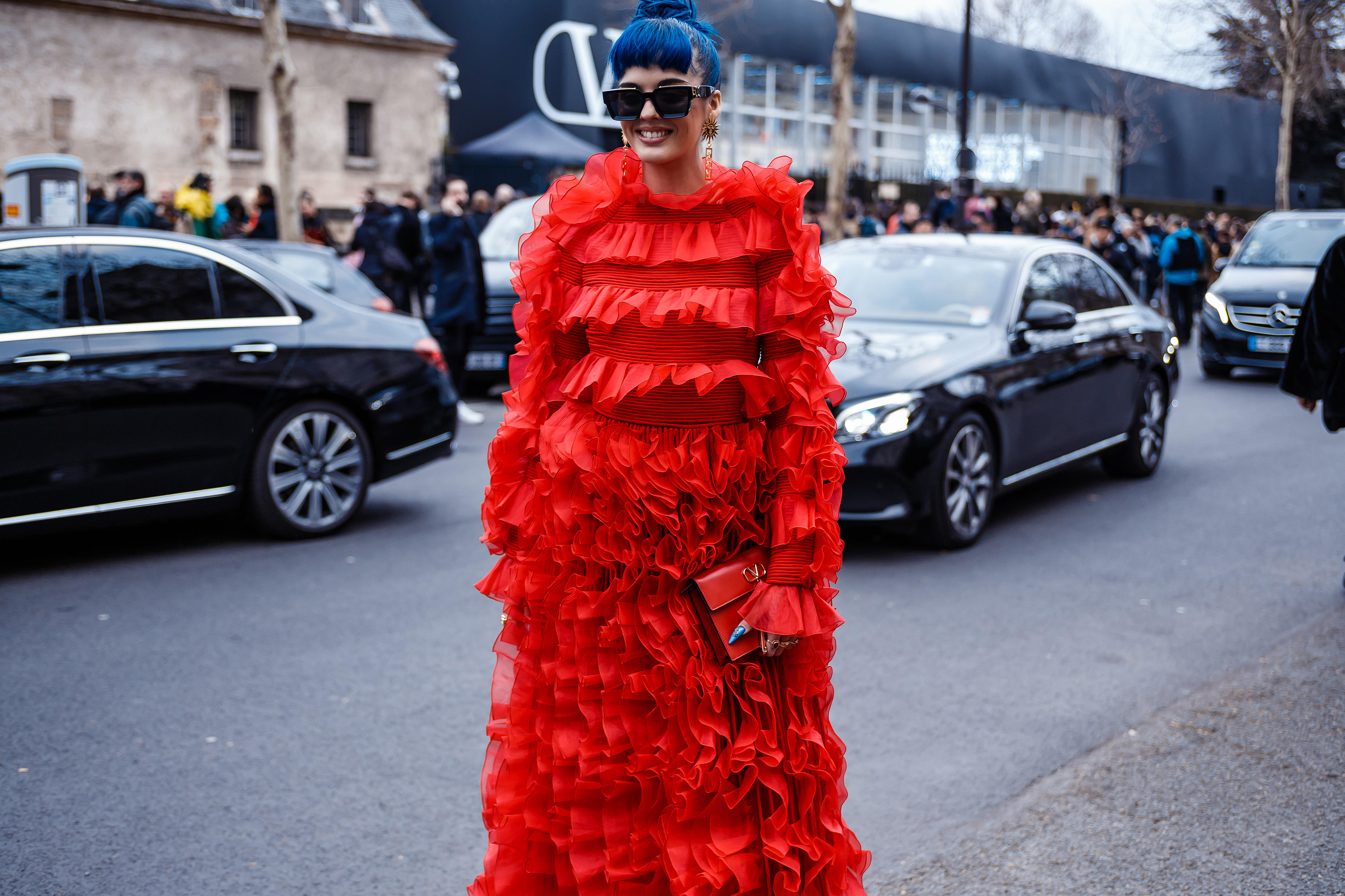 Woman in red Valentino gown at Milan Fashion Week