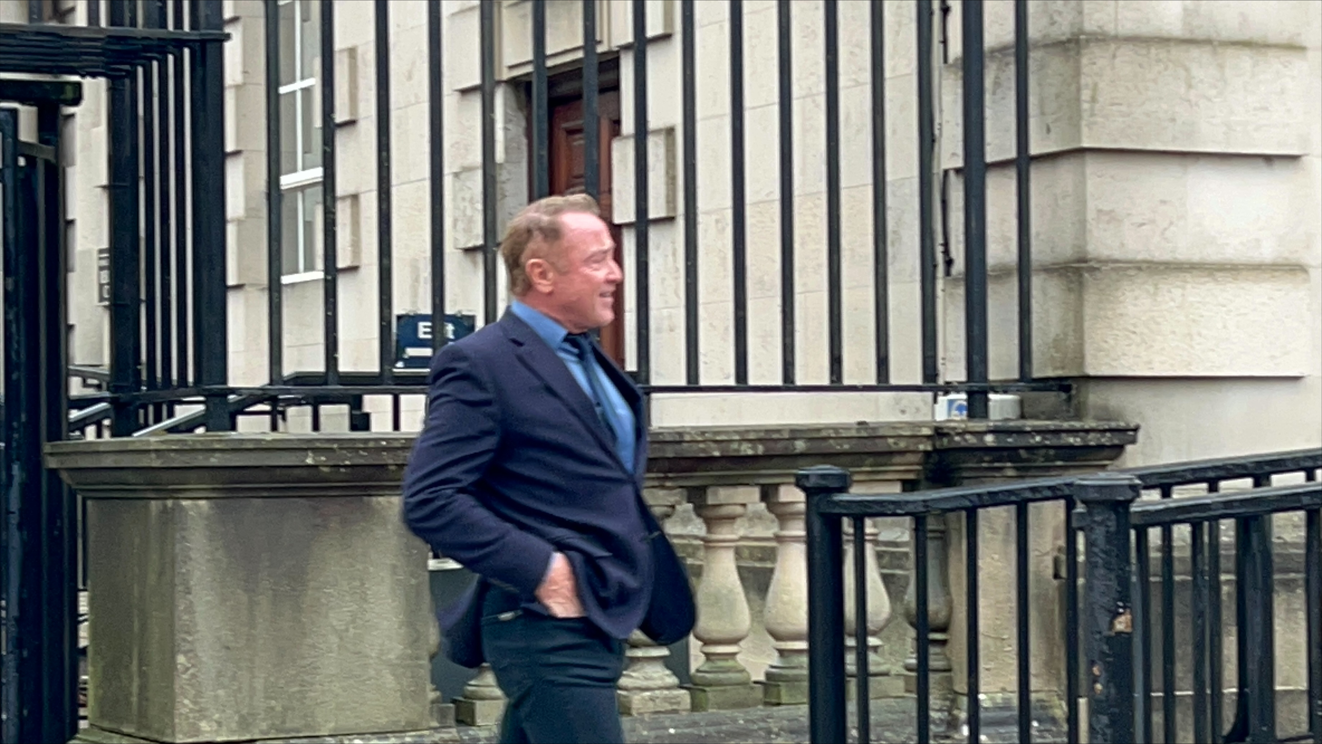 Michael Flatley walking outside a court building