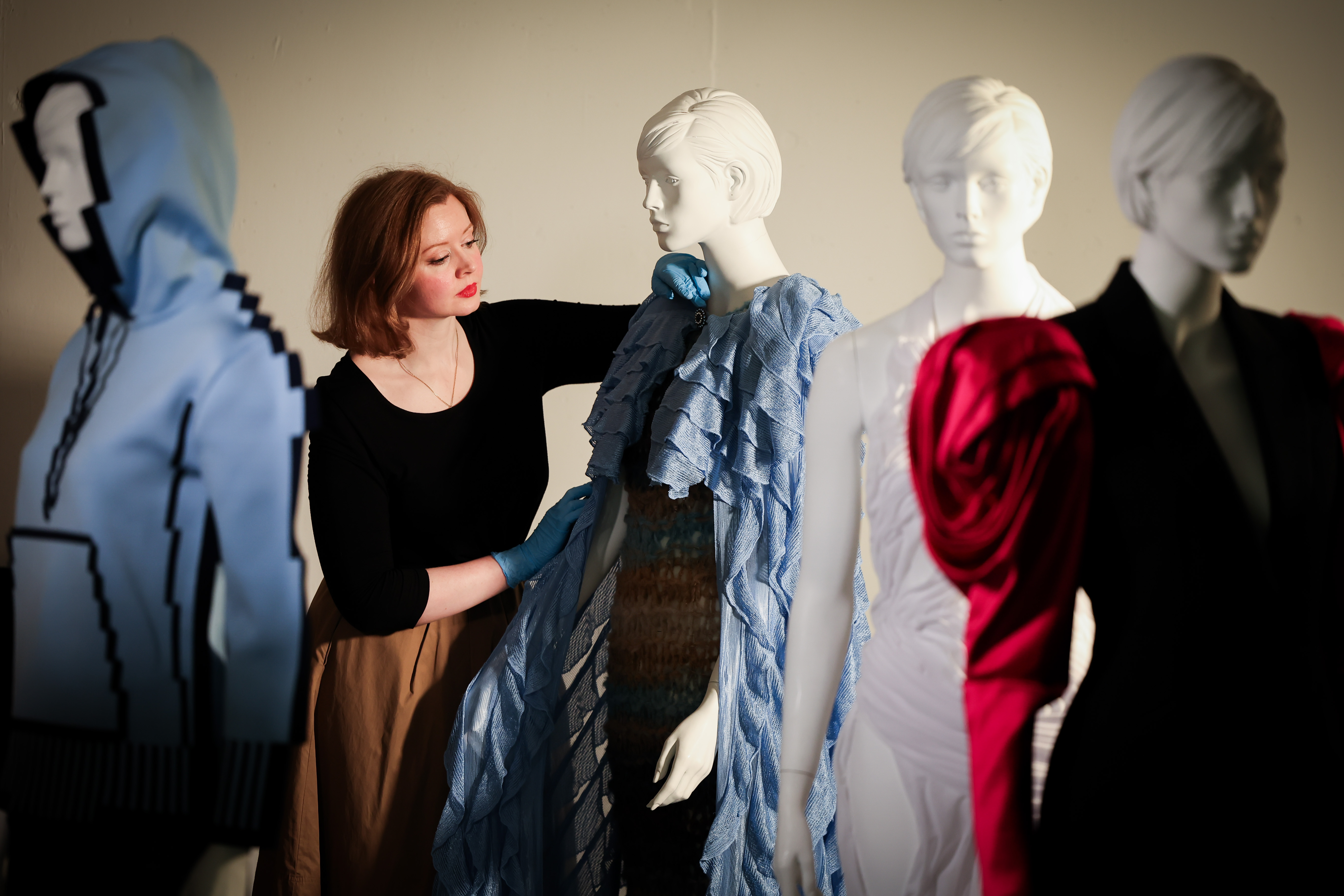 Charlotte McReynolds, curator of art at National Museums NI, putting the final touches to the Ashes to Fashion exhibition at the Ulster Museum