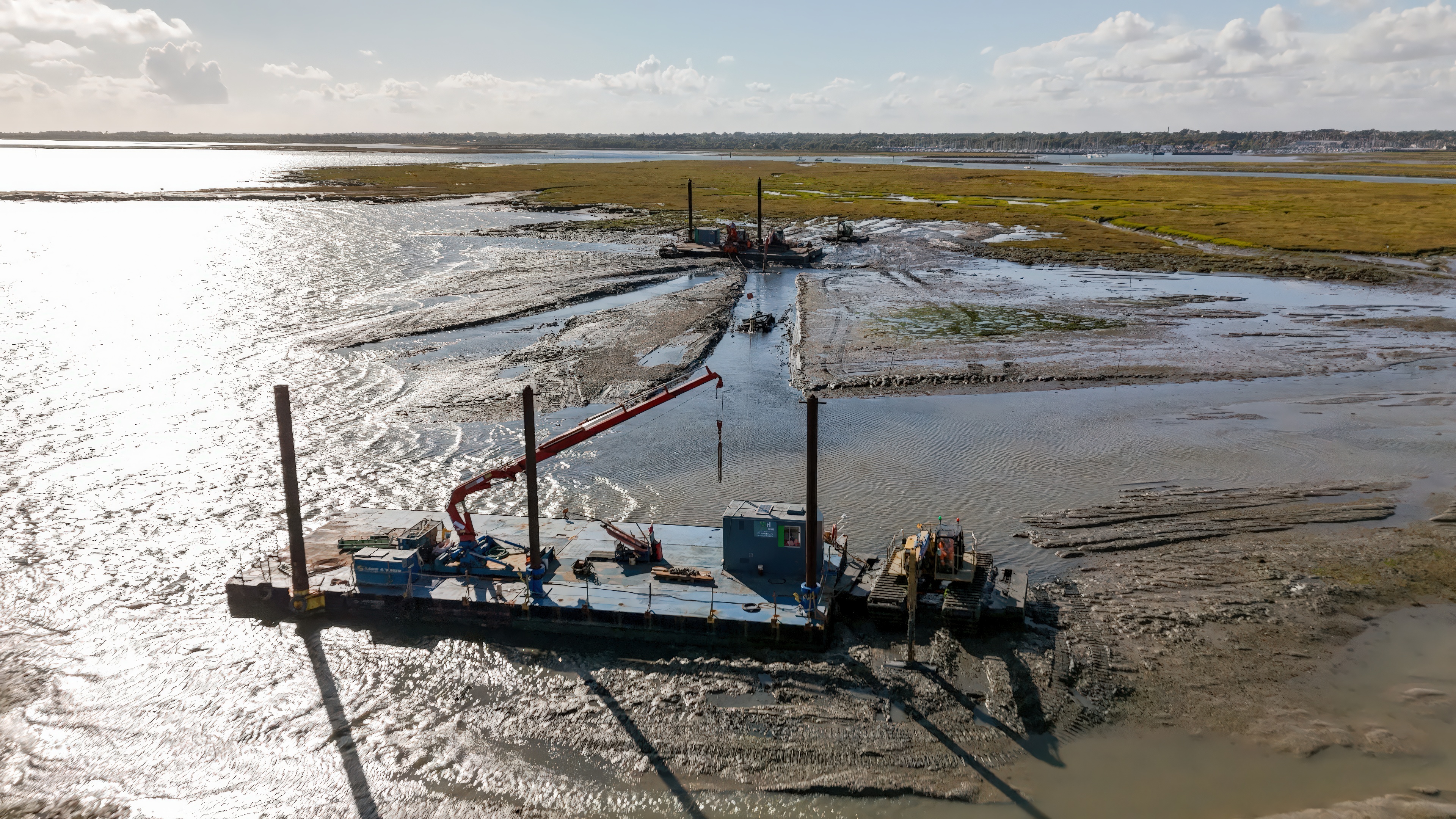 View of equipment being used to put sediment into the saltmarsh 