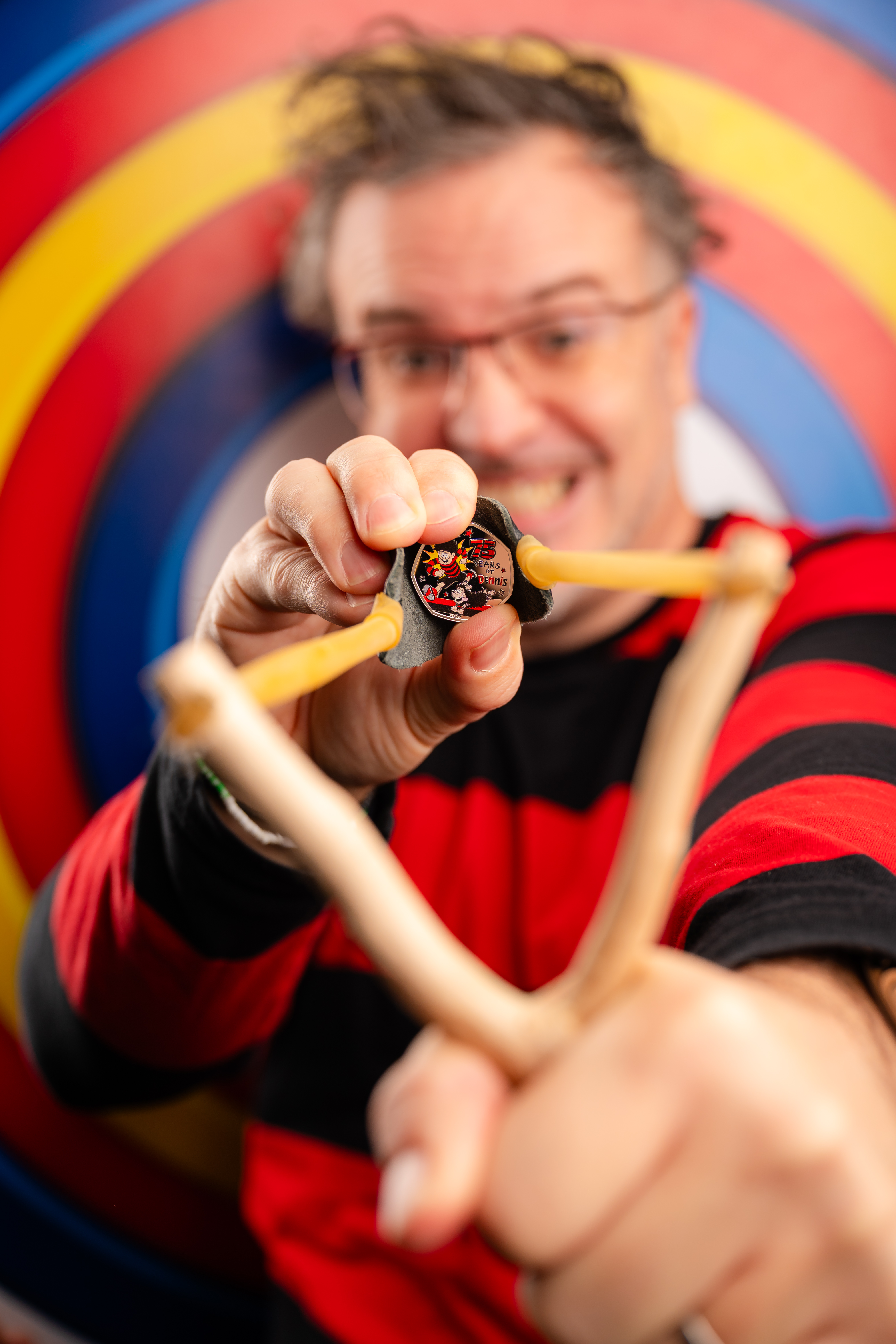 A 50p coin being used as a catapult