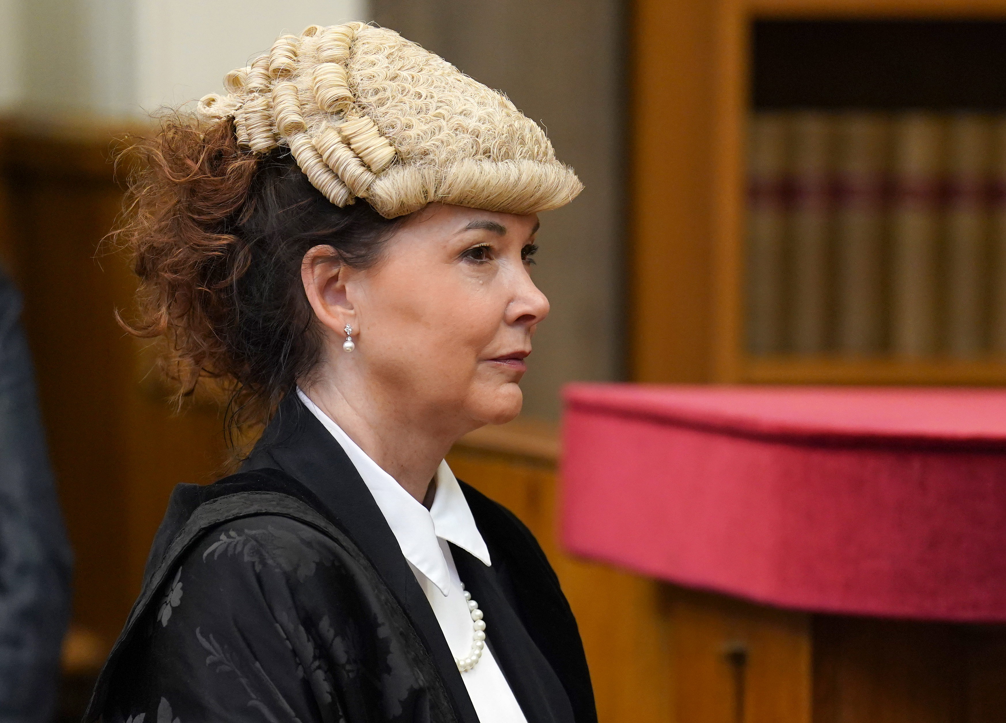 Side view headshot of Dorothy Bain KC, wearing an advocate's wig