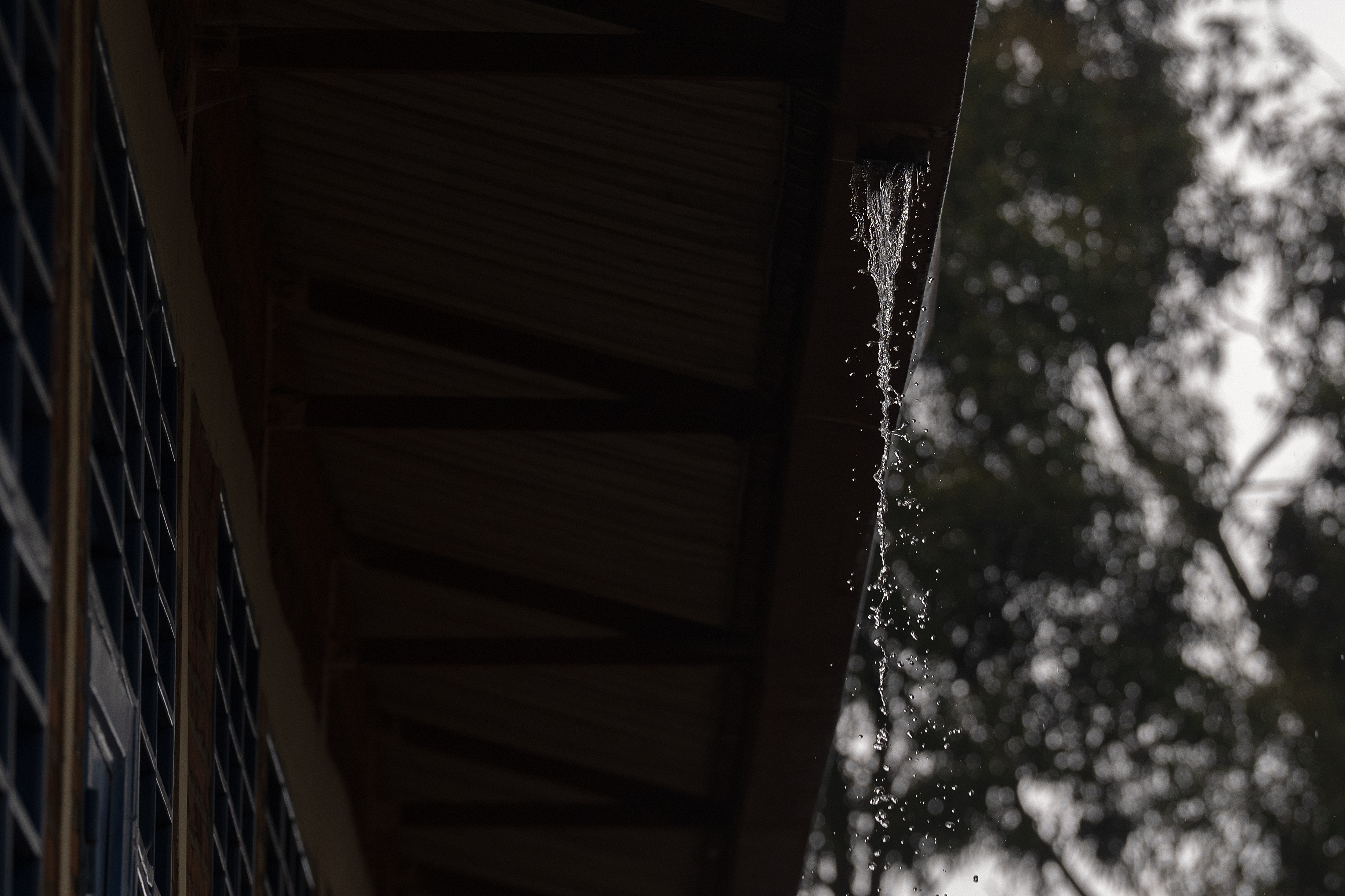 Rain falling from a gutter