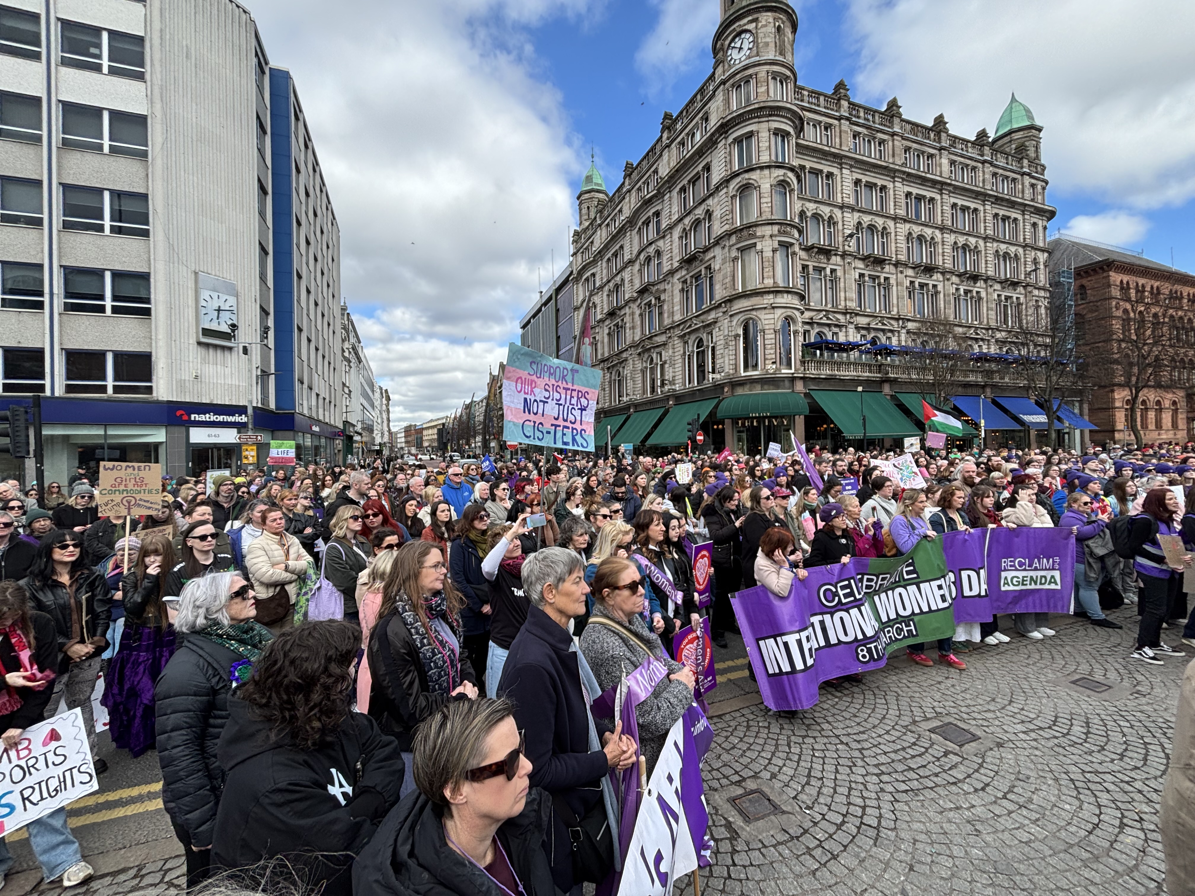 Crowds listen to speakers at the International Women's Day rally