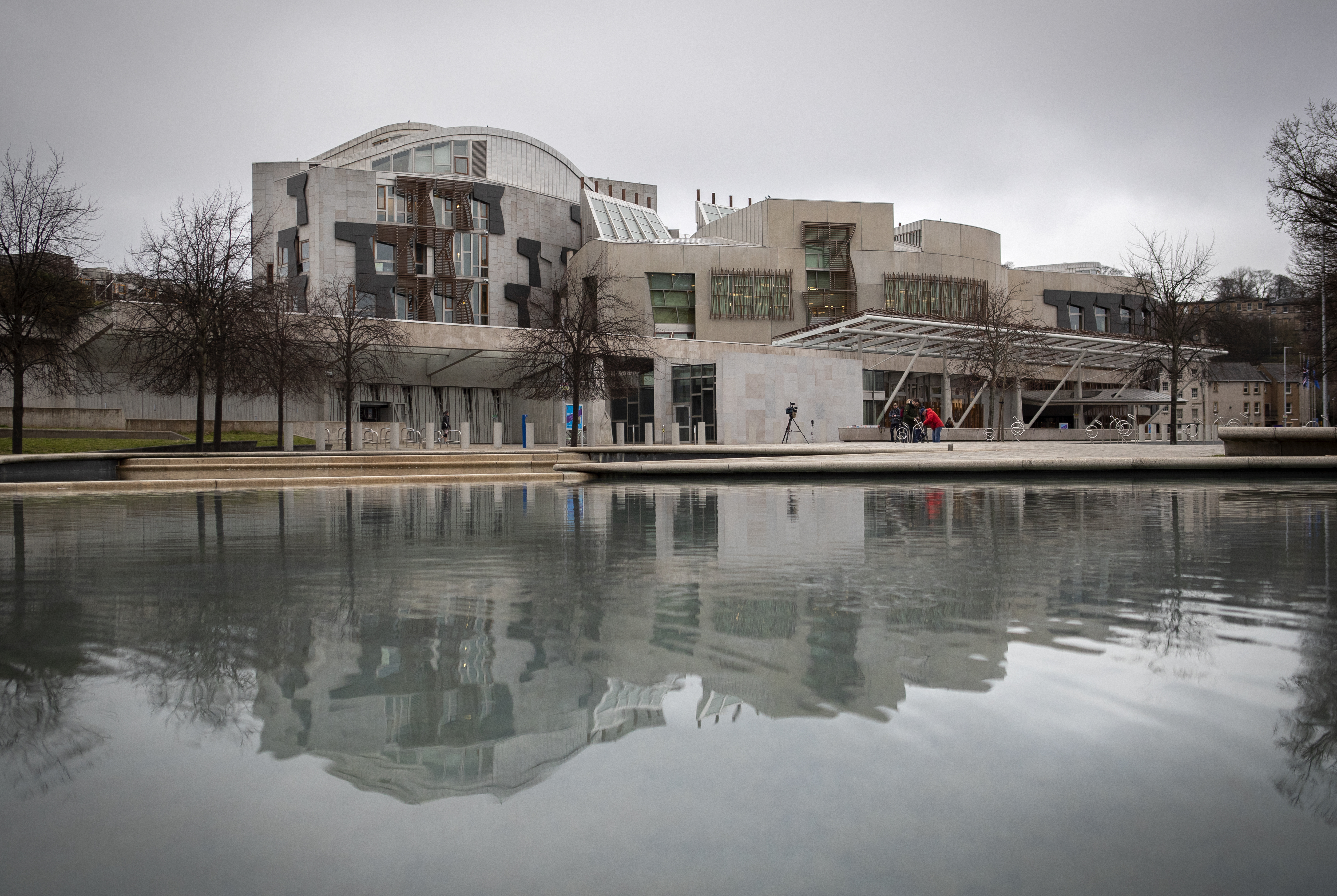 External view of the Holyrood building, with a pool of water in the foreground