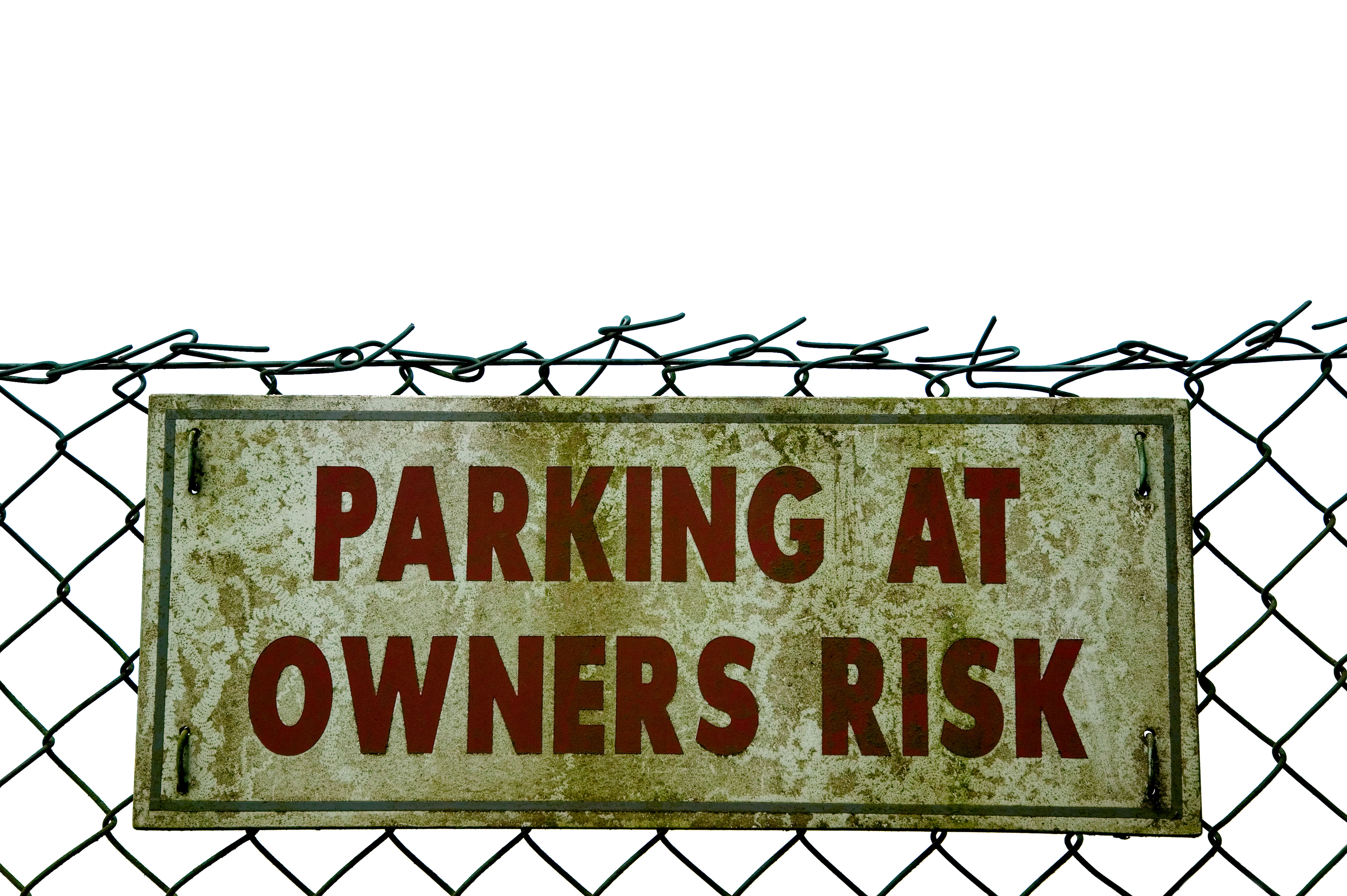 A grimy parking sign warning owners