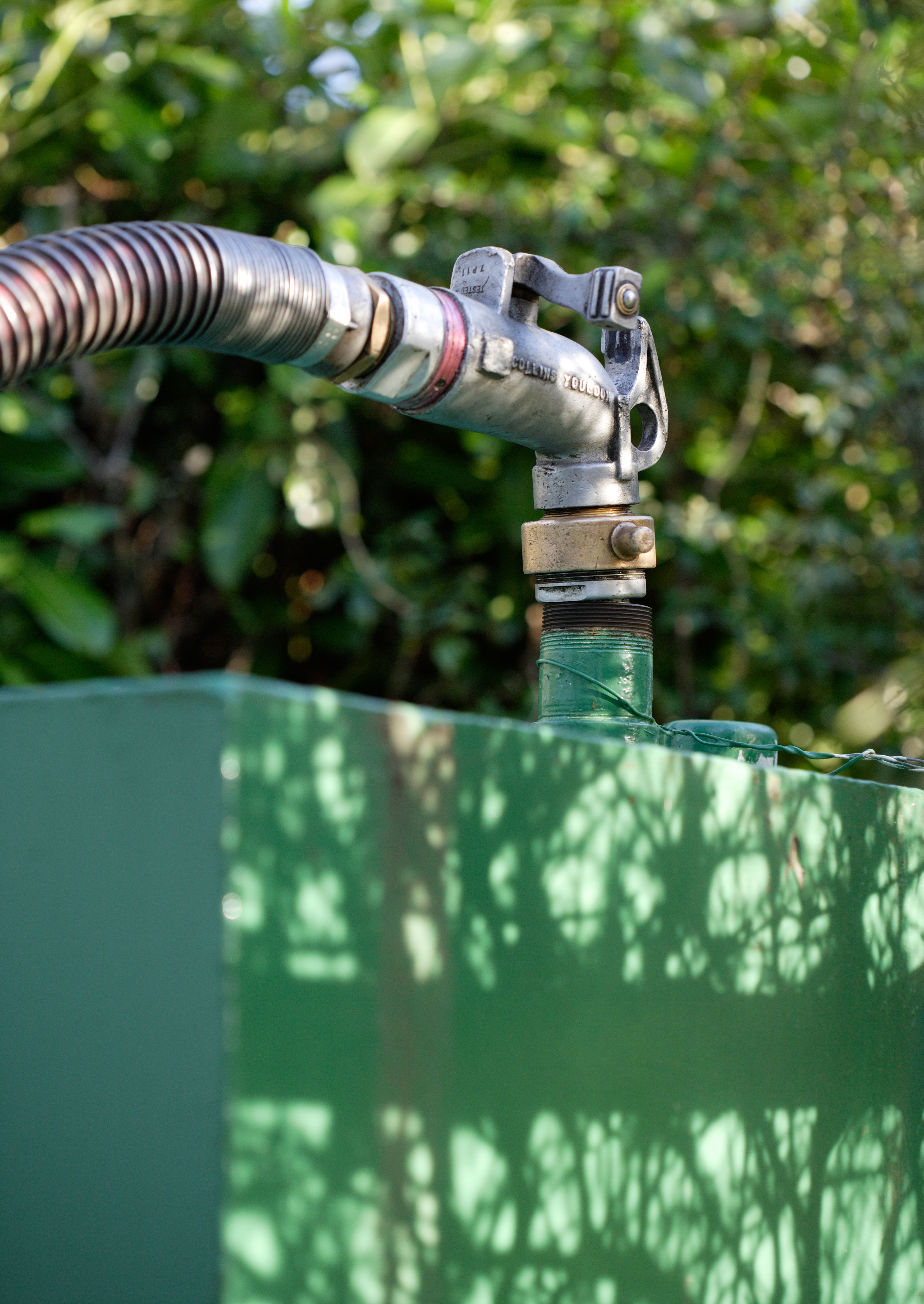 Household heating oil tank being filled by pump