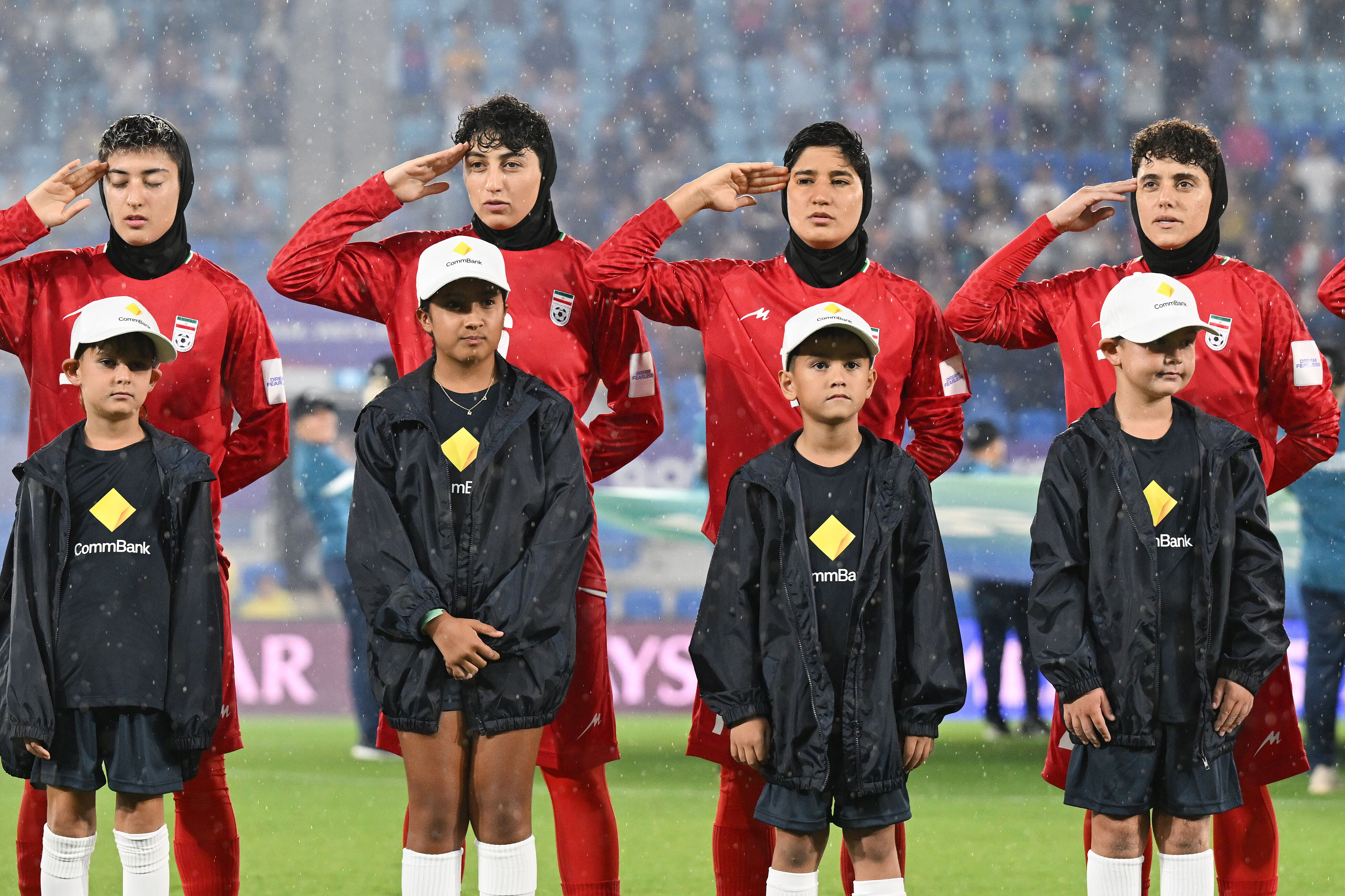 Iran players salute during their national anthem ahead of the Women's Asian Cup match between Iran and the Philippines in Robina, Australia, on March 8 