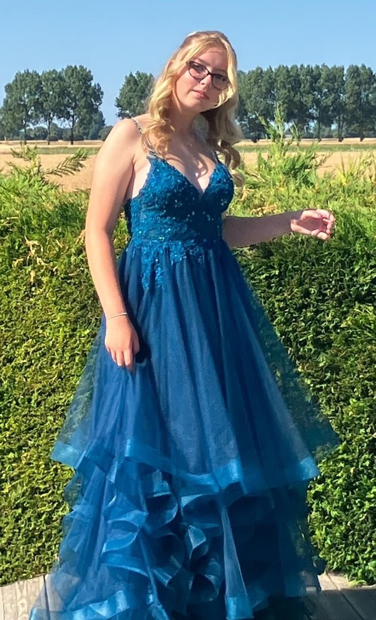 Handout photo of Eden Bunn, standing outside while wearing a blue floor-length gown