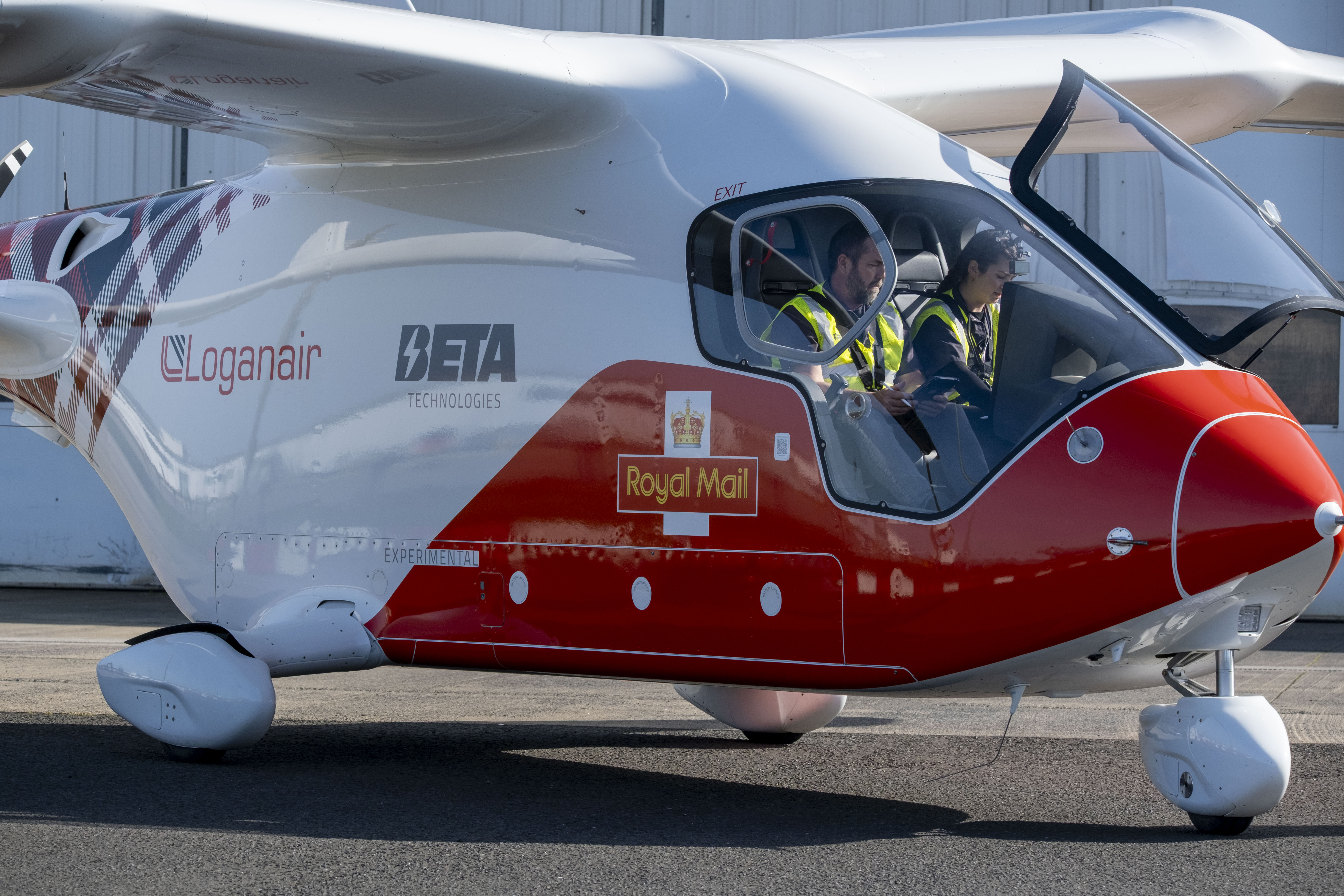 Pilots prepare to fly one of the electric aircraft