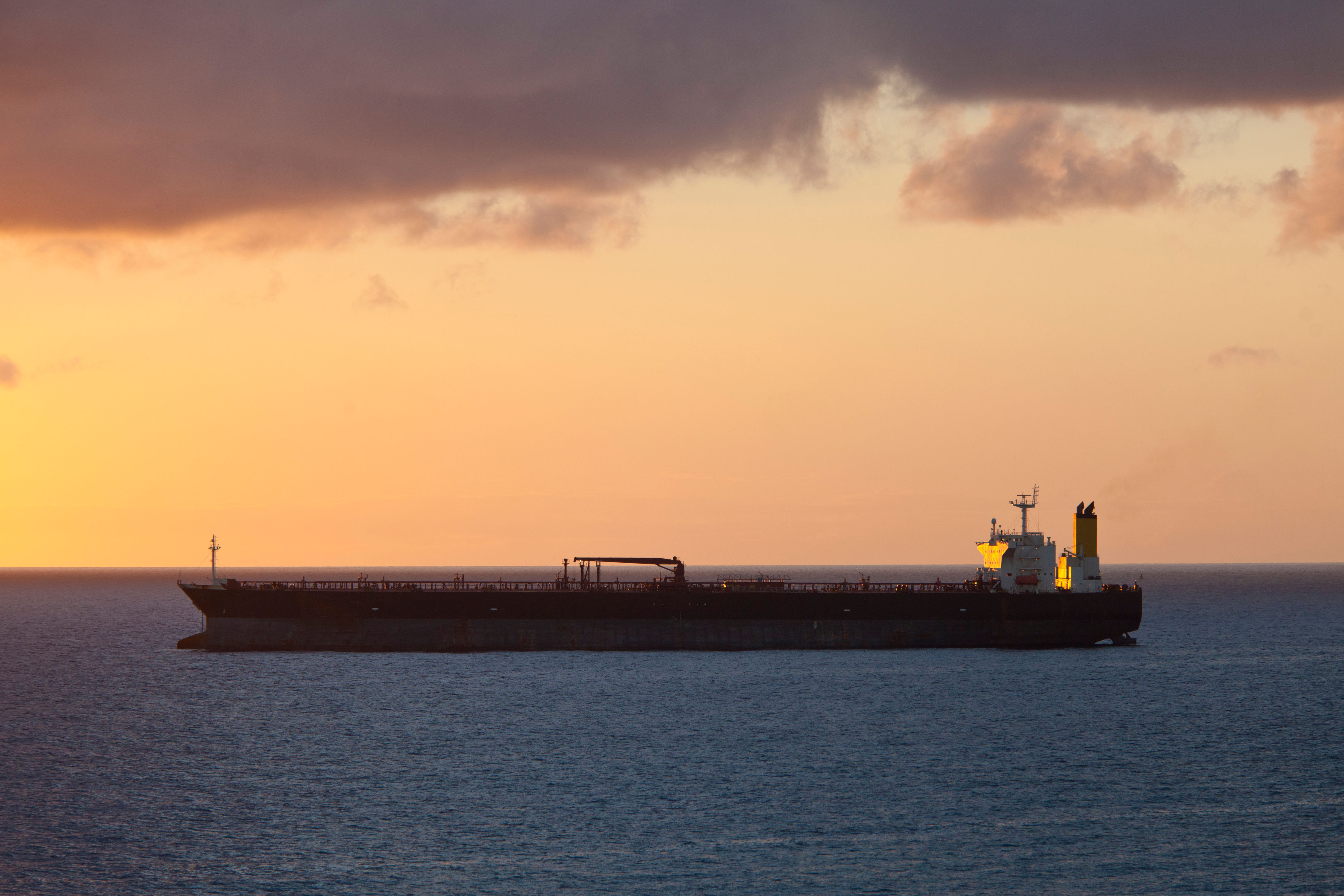 Oil tanker at sea at sunset