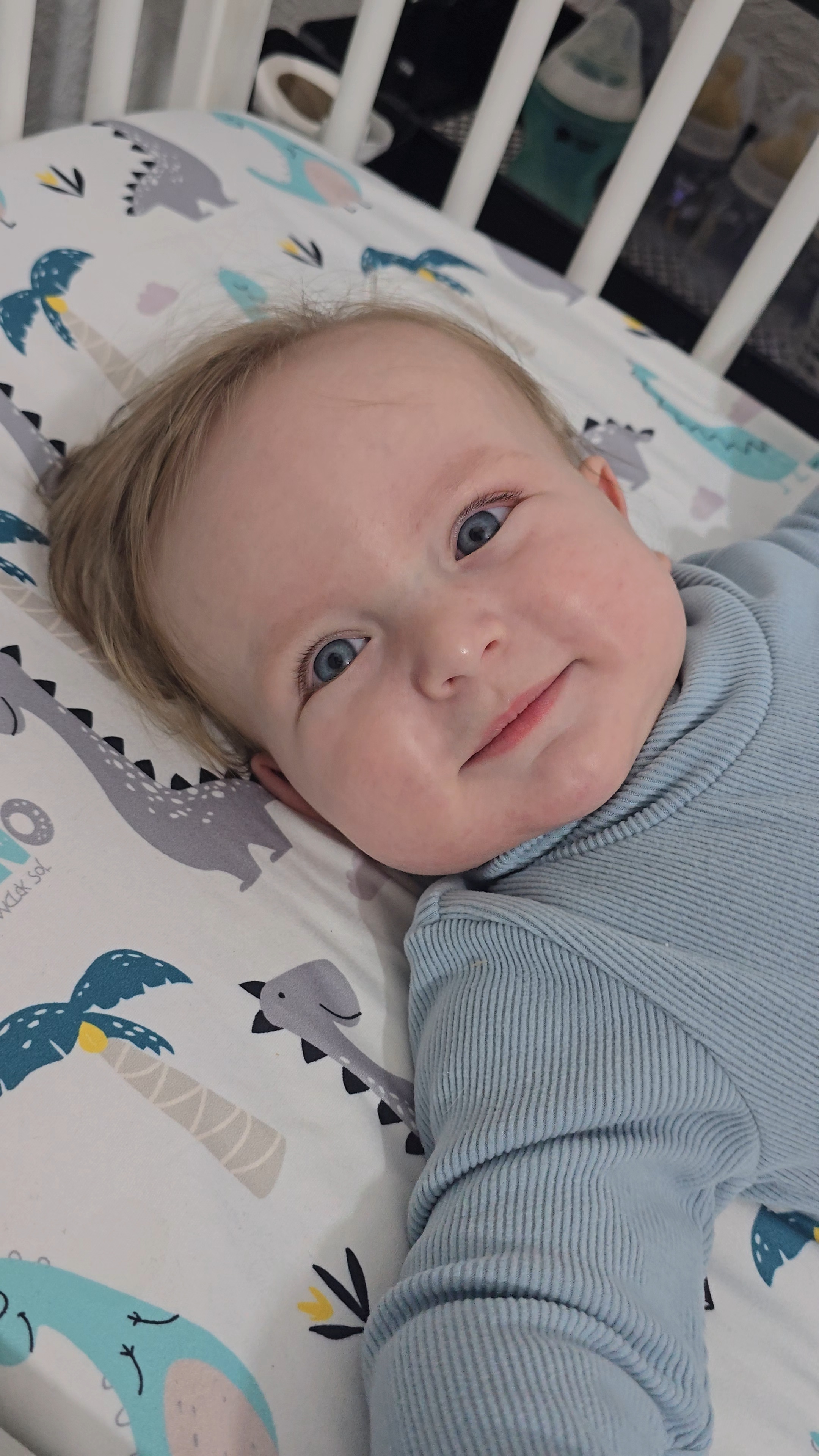 David Nica smiling while lying in a cot