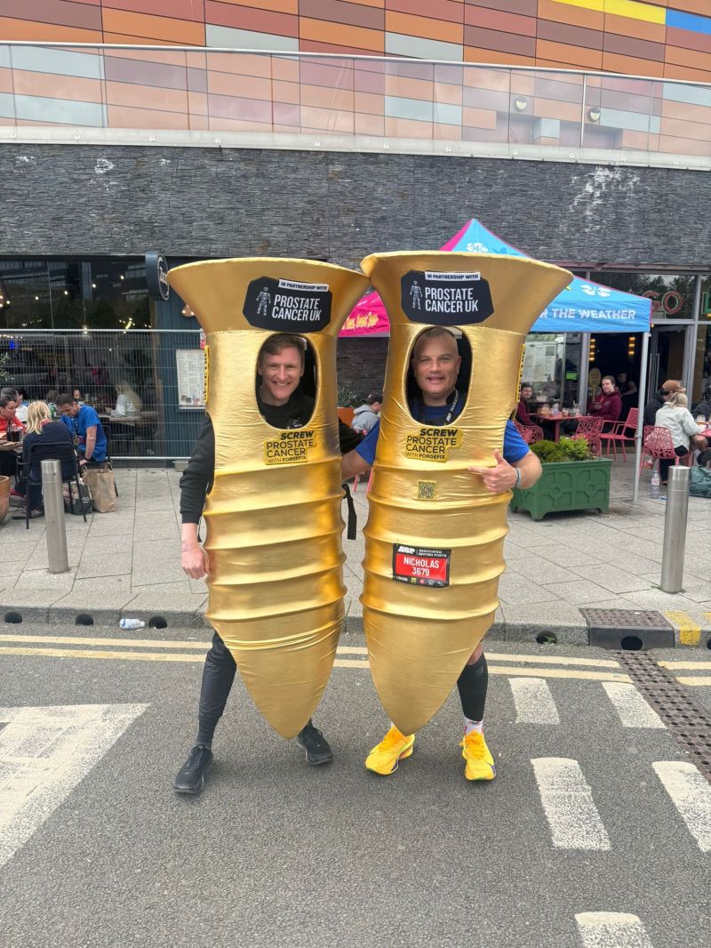 George Strong and Nick Marshall wearing gold screw costumes 