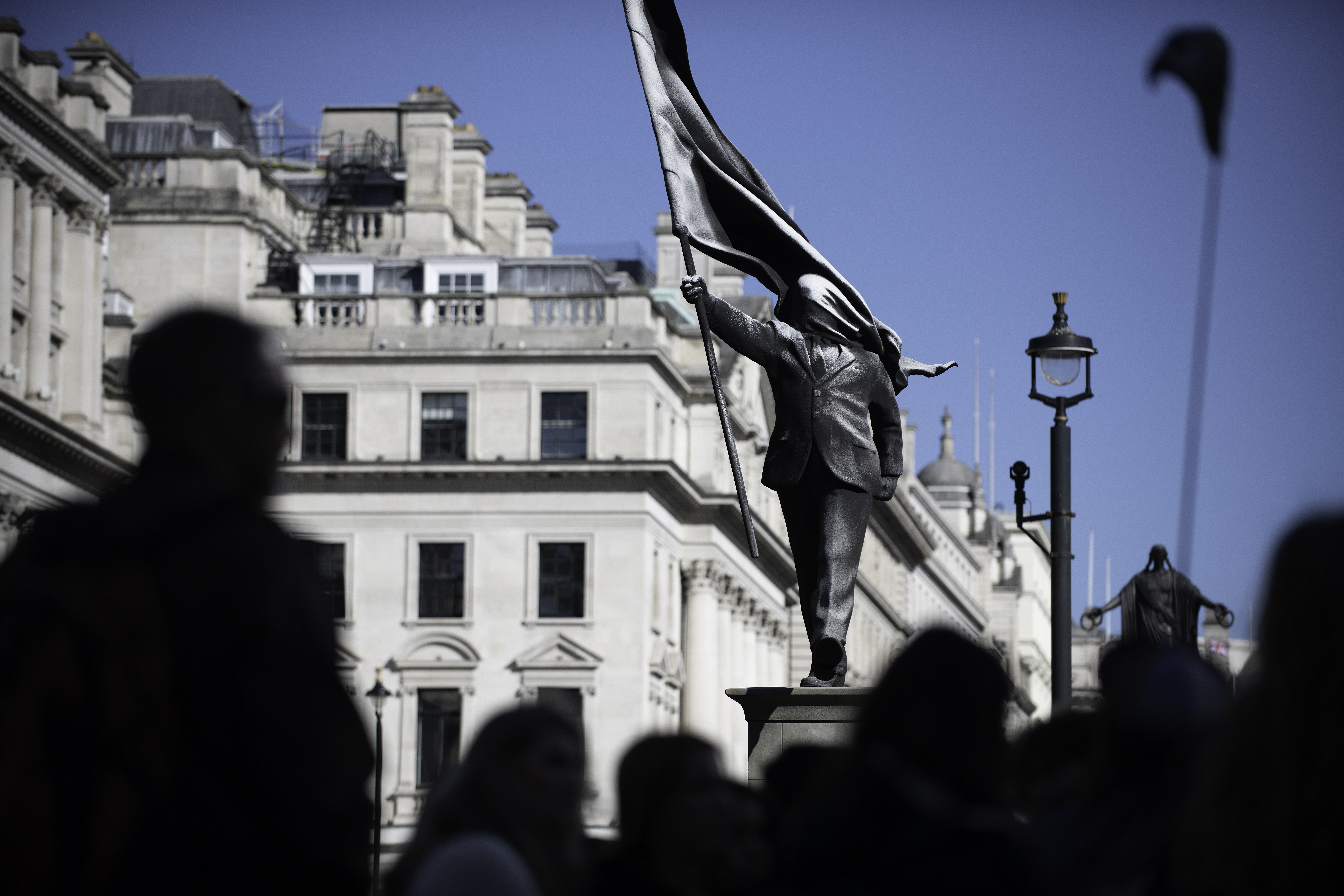 View of Banksy statue, with onlookers
