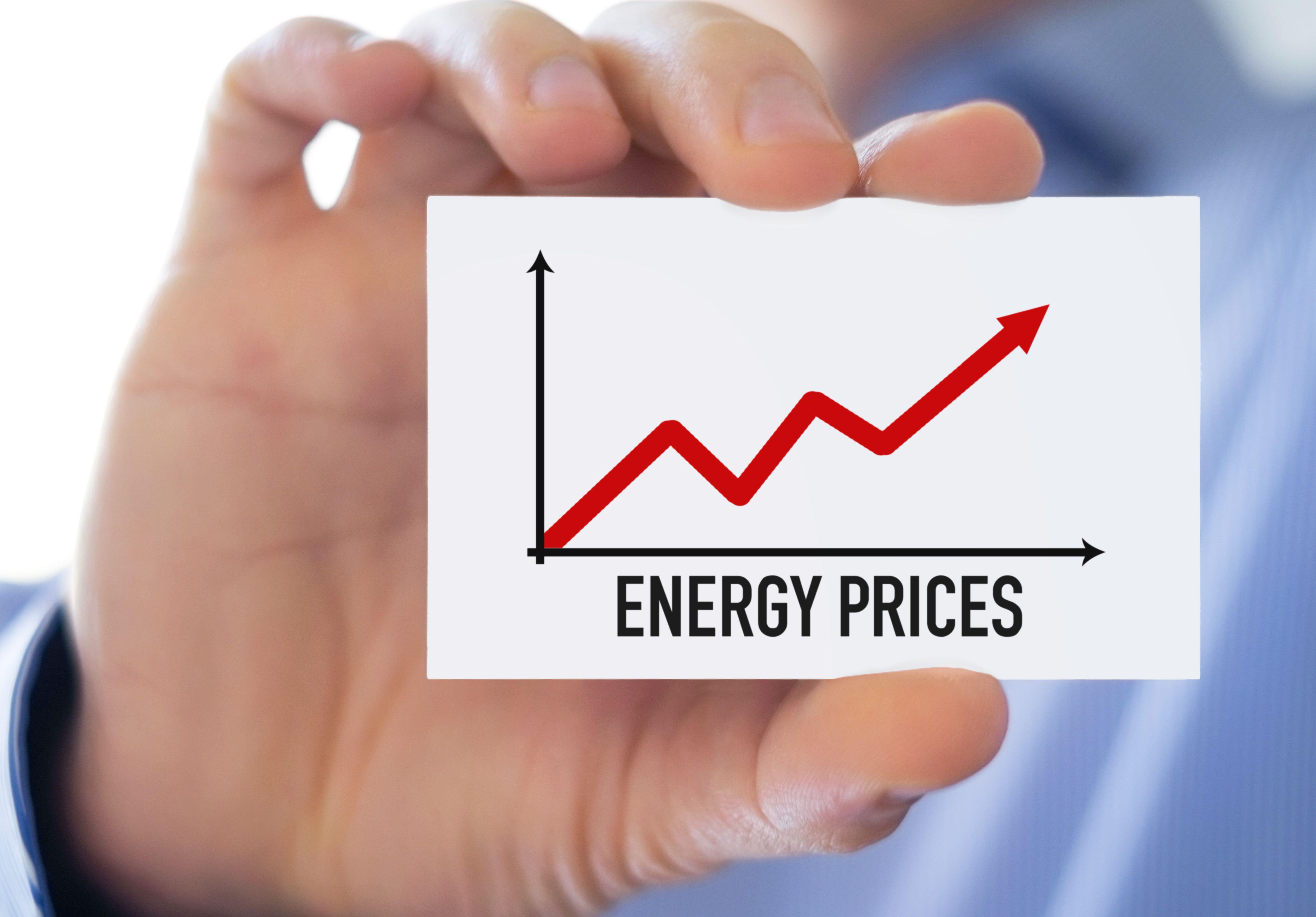 Man holding piece of paper which displaying graph of energy prices increasing 