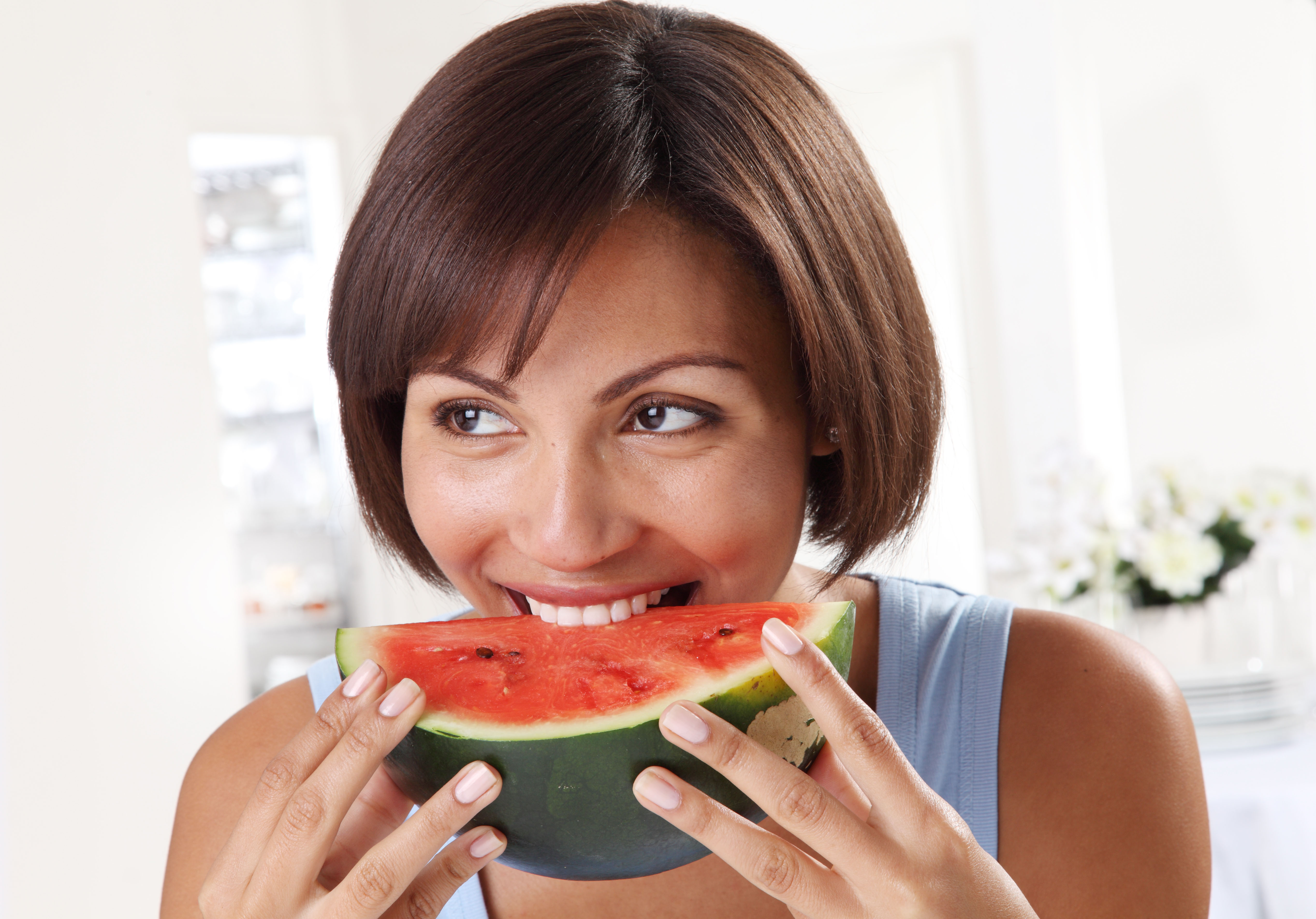 Young woman eating a watermelon slice 