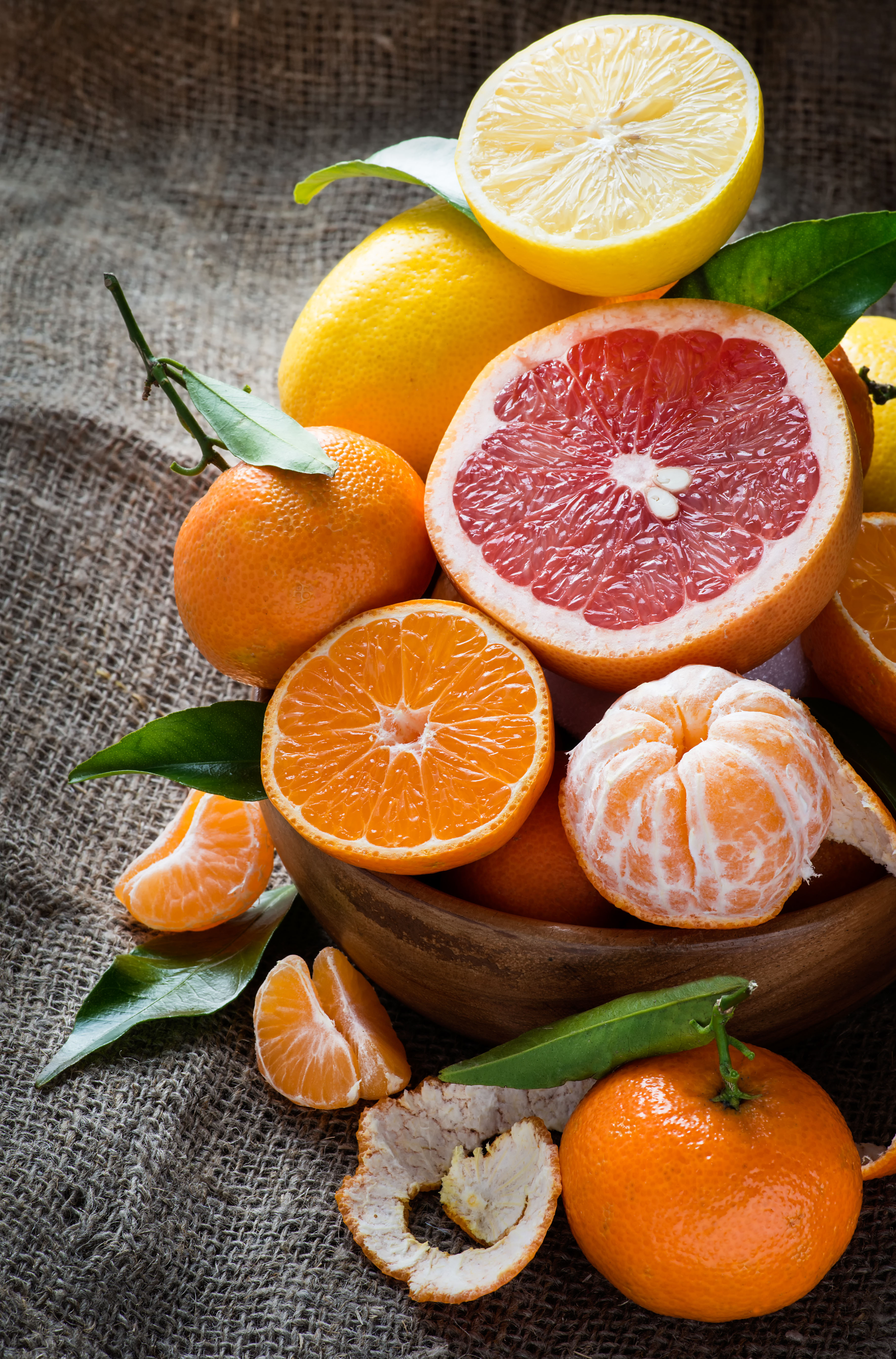 Fresh citrus fruits on rustic background 