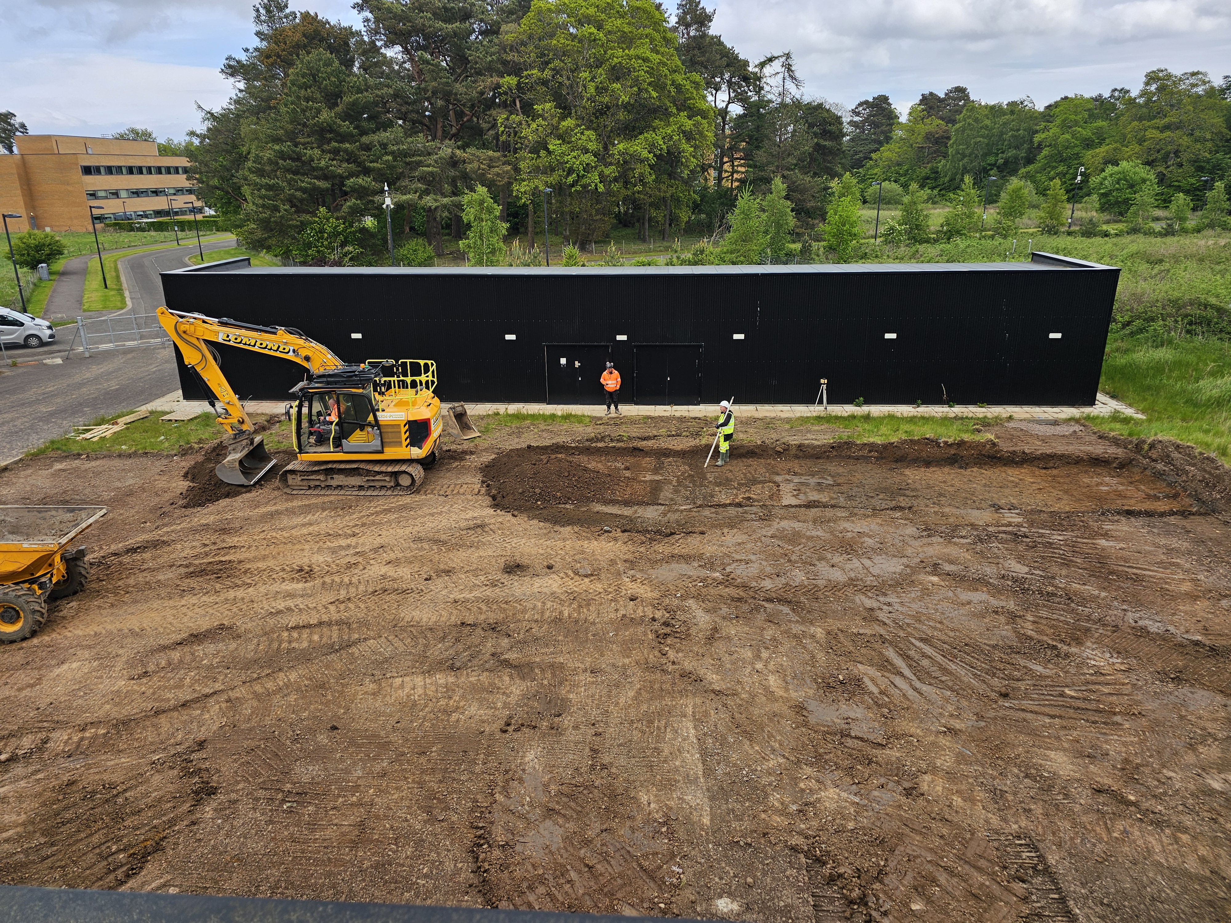 A digger and workmen at a construction site