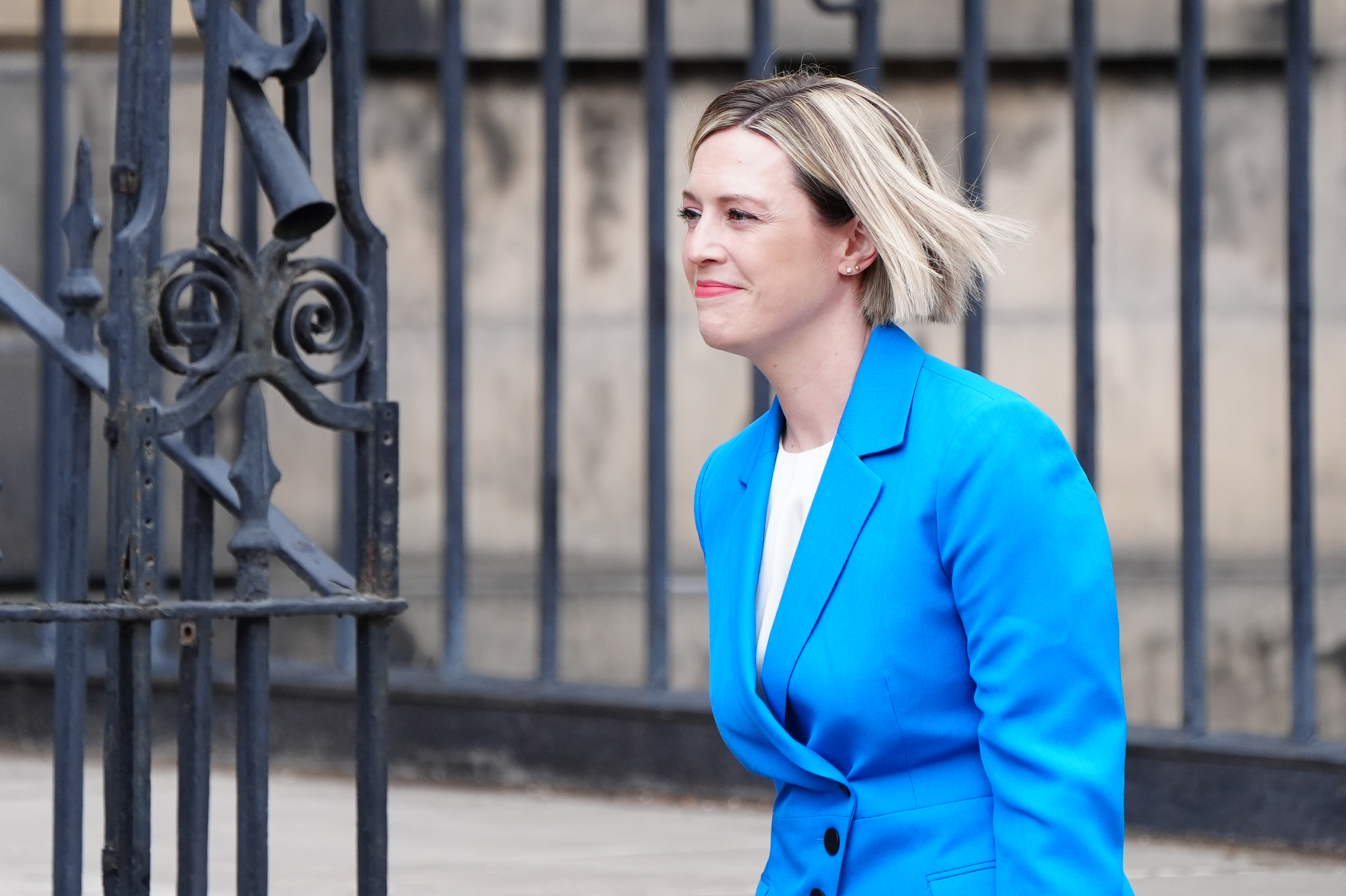 Side view of Jenny Gilruth smiling while walking outside Bute House