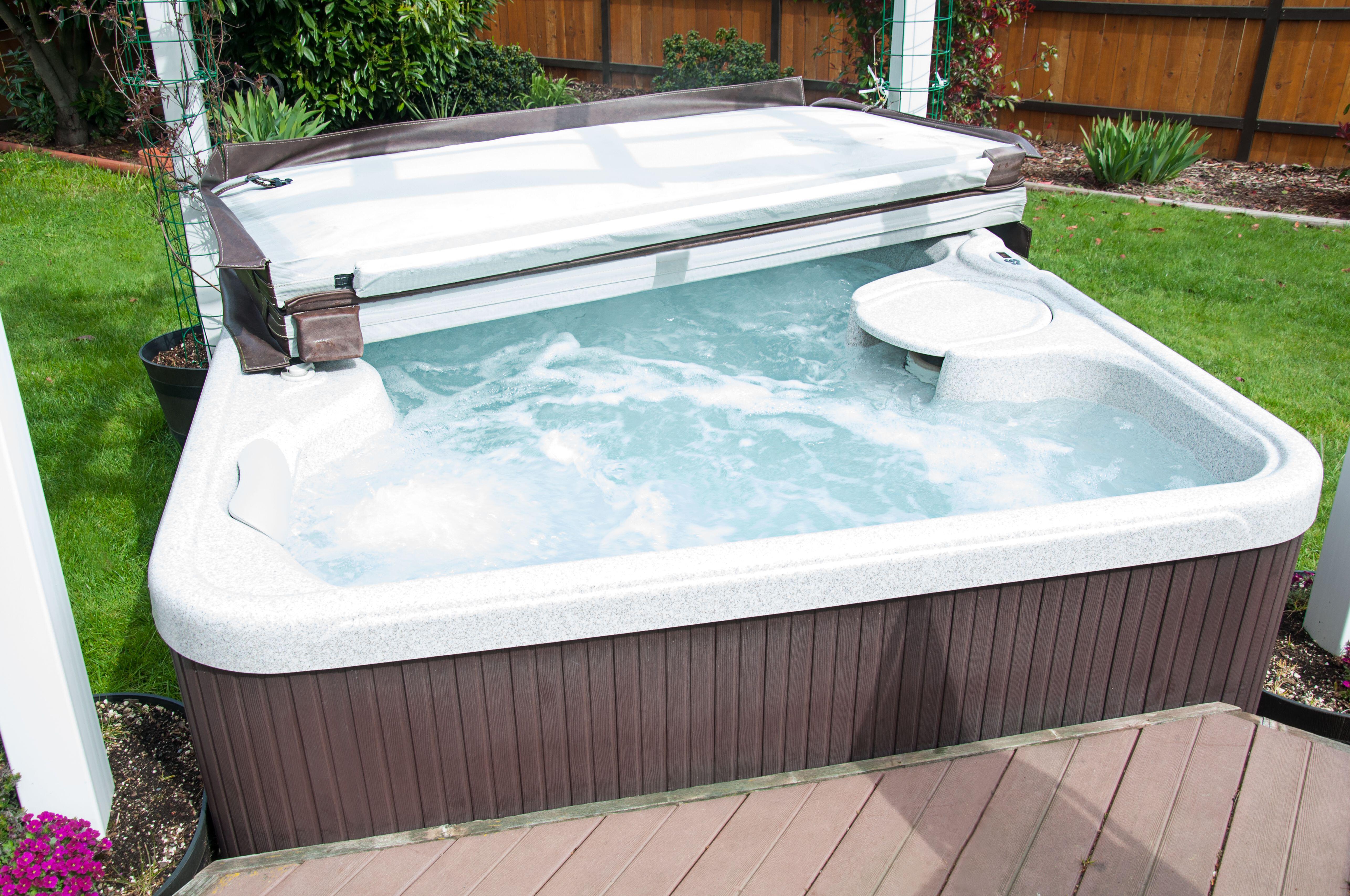 A hot tub in a back garden