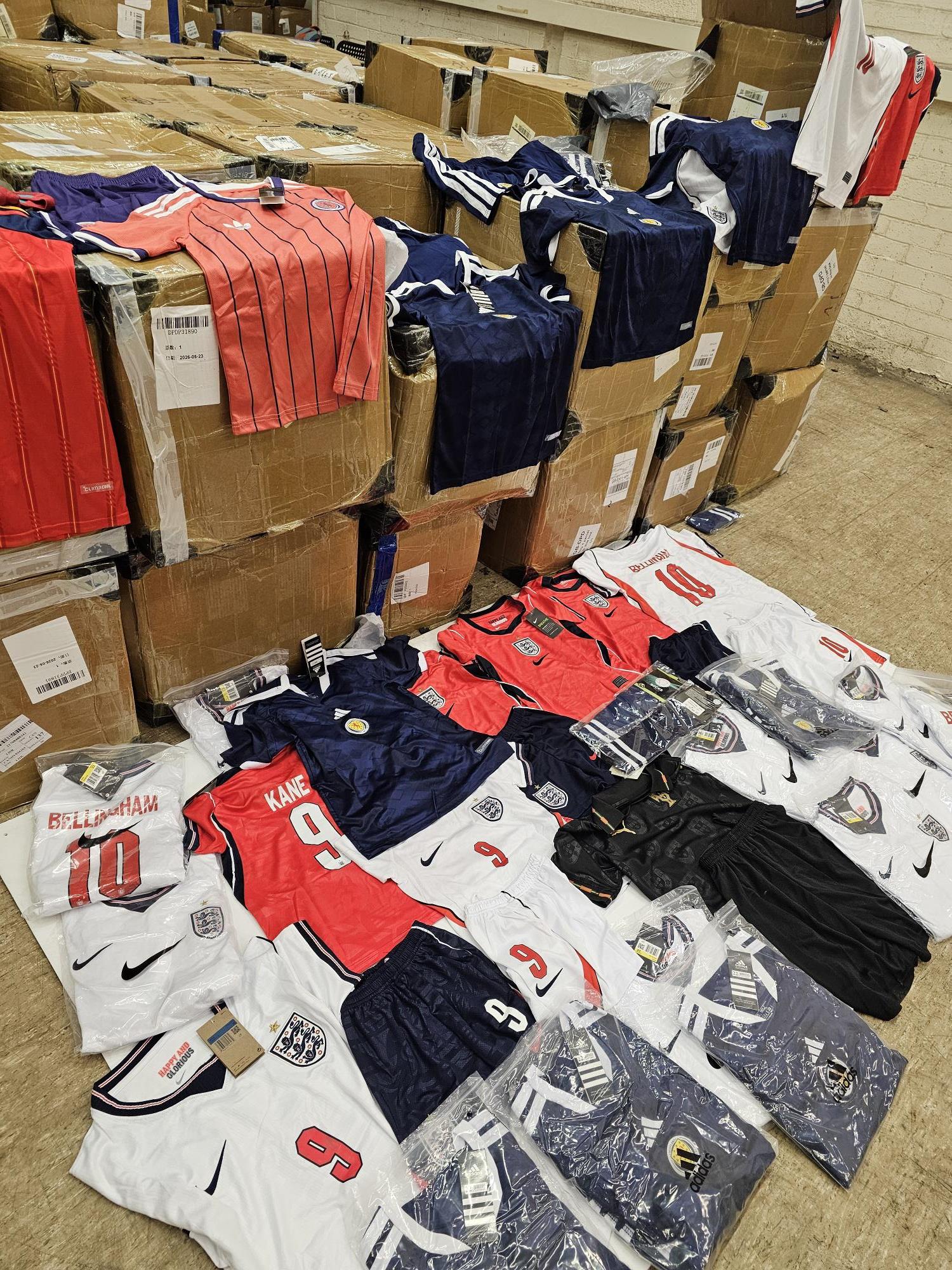 Counterfeit Scotland and England shirts lying on the floor, and on top of boxes