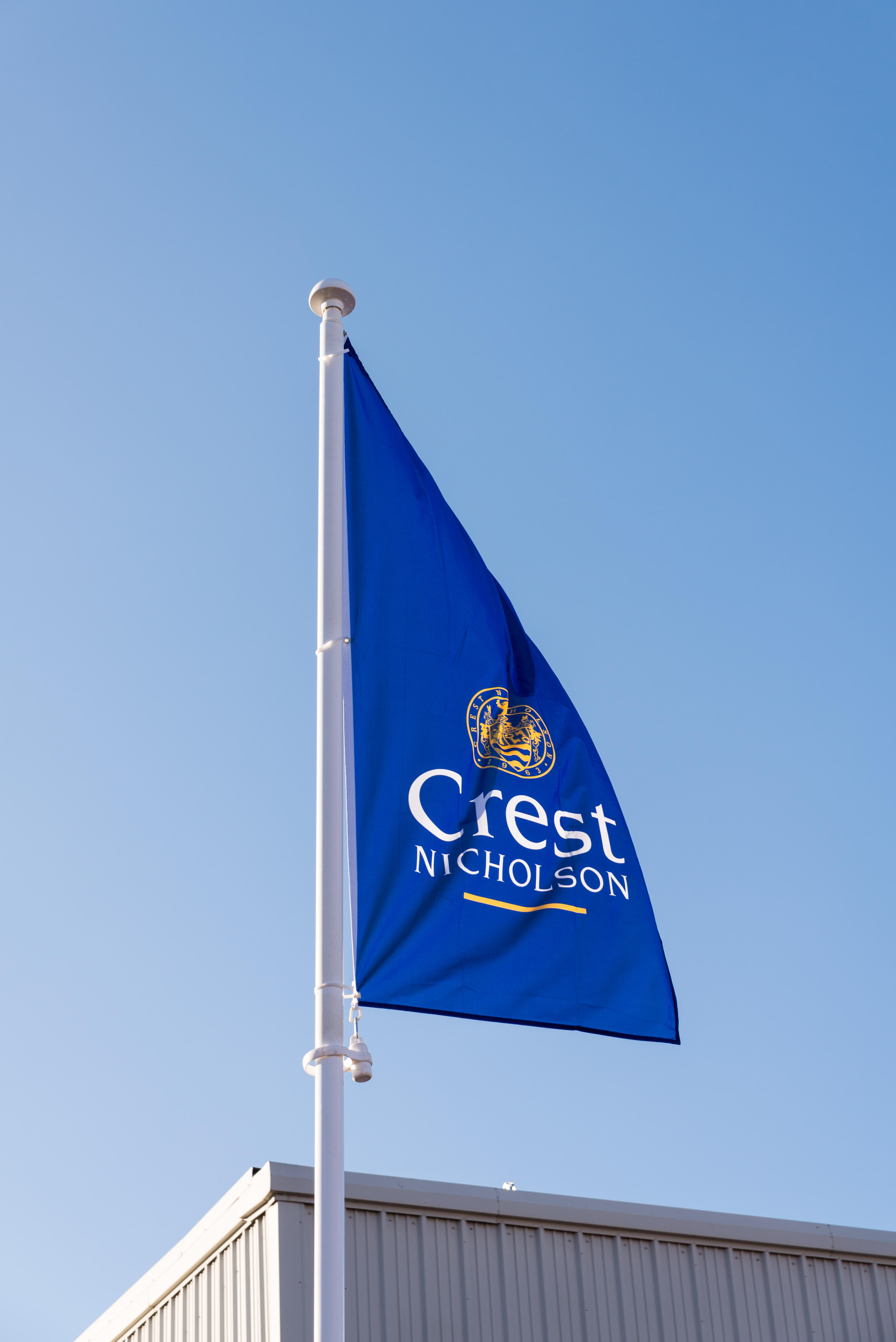 Crest Nicholson house builders blue flag flying on construction site